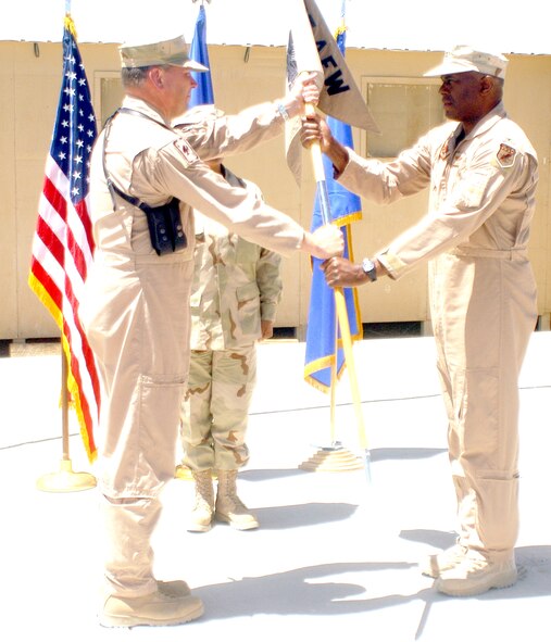 BAGRAM AIRFIELD, Afghanistan -- Col. Tony Johnson, right, takes command of the 455th Expeditionary Operations Group from Brig. Gen. Chris Miller, 455th Air Expeditionary Wing commander, here May 13.  Colonel Johnson is an Air Force reservist deployed here from the 442nd Fighter Wing, Whiteman Air Force Base, Mo.  He will be oversee a deployed A-10 squadron, C-130 squadron, an aeromedical evacuation squadron and other operational units here to support the Operation Enduring Freedom in Afghanistan.  (US Air Force Photo by Maj. David Kurle, 455 AEW/PA)