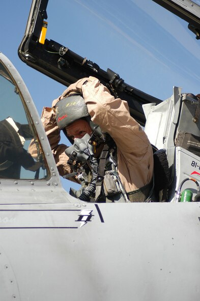 BAGRAM AIRFIELD, Afghanistan -- Lt. Col. Stephen Chappel, an A-10 pilot deployed to the 455th Air Expeditionary Wing here, puts on his flight helmet in preparation to fly a combat mission over Afghanistan May 13.  Colonel Chappel is an Air Force Reservist deployed from the 442nd Fighter Wing, based at Whiteman Air Force Base, Mo.  (US Air Force photo by Maj. David Kurle, 455 AEW/PA)