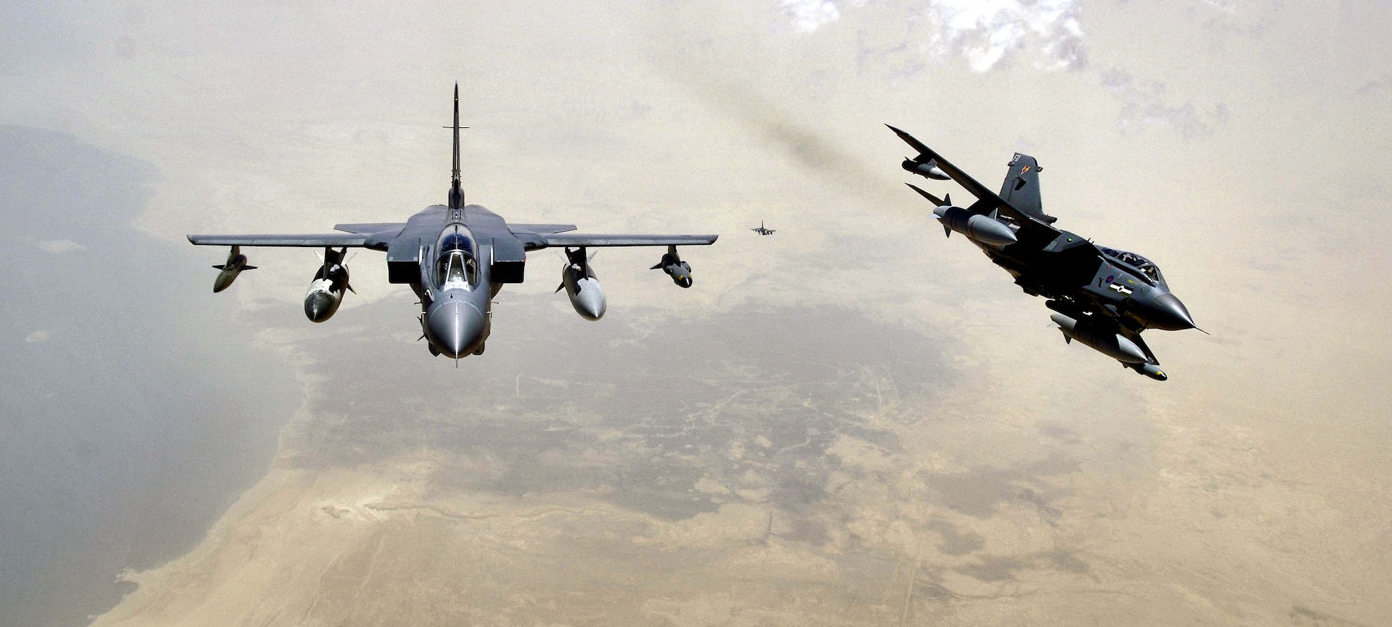 Two RAF Tornado GR-4s pull away from a KC-135 Stratotanker after refueling on Sunday, May 14, 2006. The Tornados and crews are from the 617th Squadron at RAF Lossiemouth, Scotland. The KC-135 and crew are deployed to the 340th Expeditionary Air Refueling Squadron from the 905th Air Refueling Squadron at Grand Forks Air Force Base, N.D. (U.S. Air Force photo/Master Sgt. Lance Cheung)