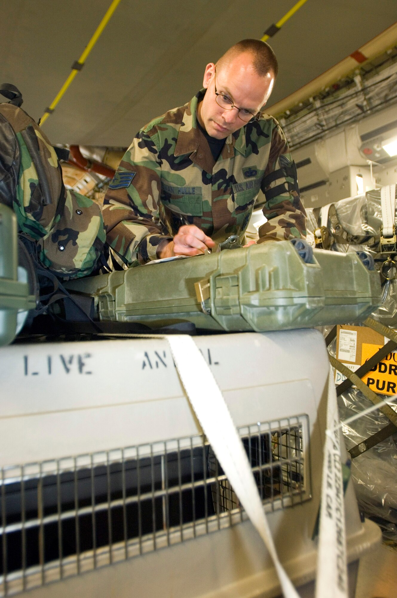 Staff Sgt. Robert Van Hulle copies information about a military working dog that arrived at Ramstein Air Base, Germany, on Tuesday, May 9, 2006. Sergeant Van Hulle is the 435th Security Forces Squadron military dog handler liaison. He finds lodging for K-9 teams, sets up veterinary appointments and makes flight arrangements for the K-9 teams transiting the base. (U.S. Air Force photo/Master Sgt. John E. Lasky) 

