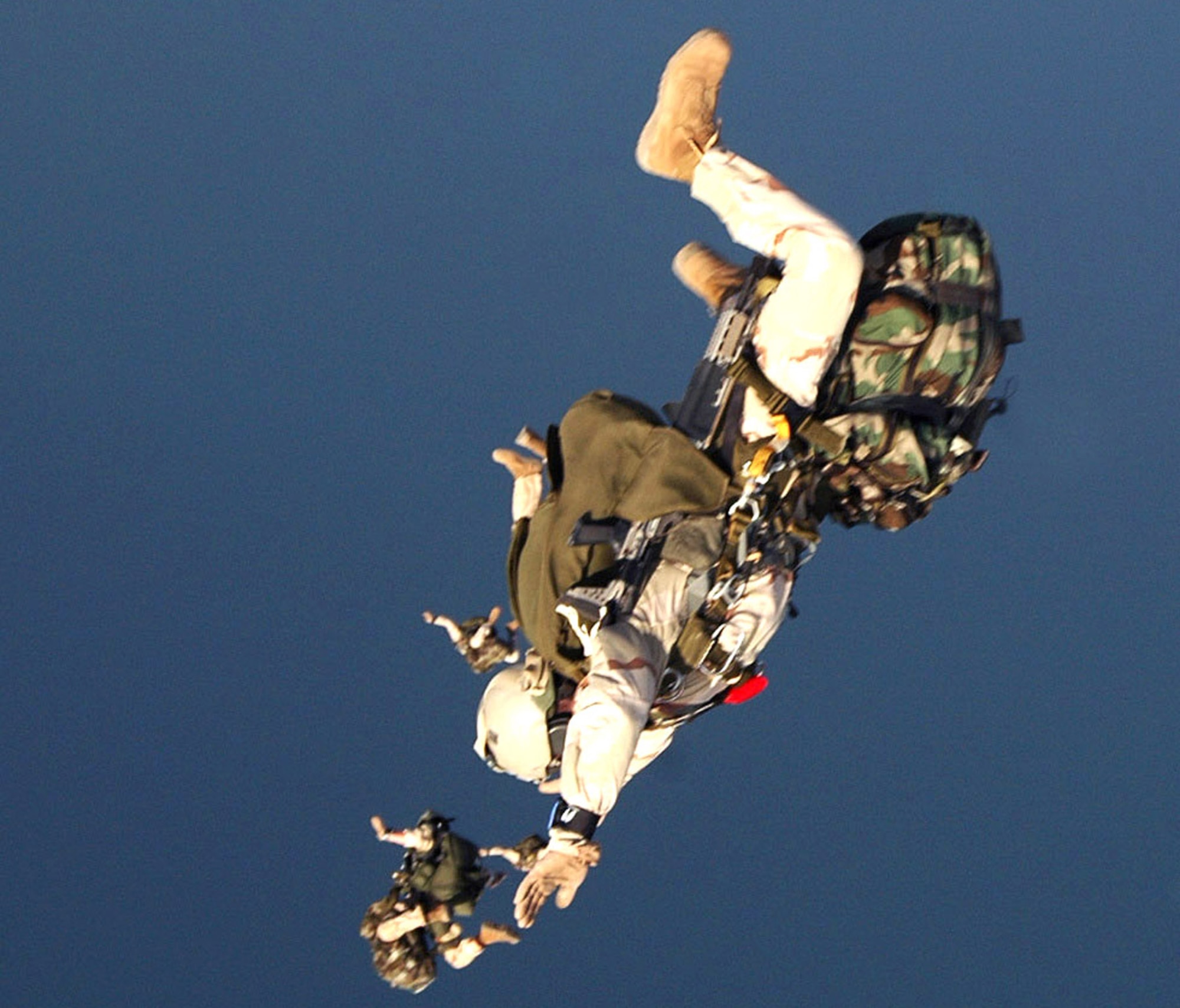 Air Force pararescuemen from the 304th Expeditionary Rescue Squadron free-fall during a high-altitude jump over the Gulf of Tadjoura in Djibouti, Africa, on Thursday, May 11, 2006. (U.S. Navy photo/Photographer's Mate 2nd Class Scott Taylor) 
