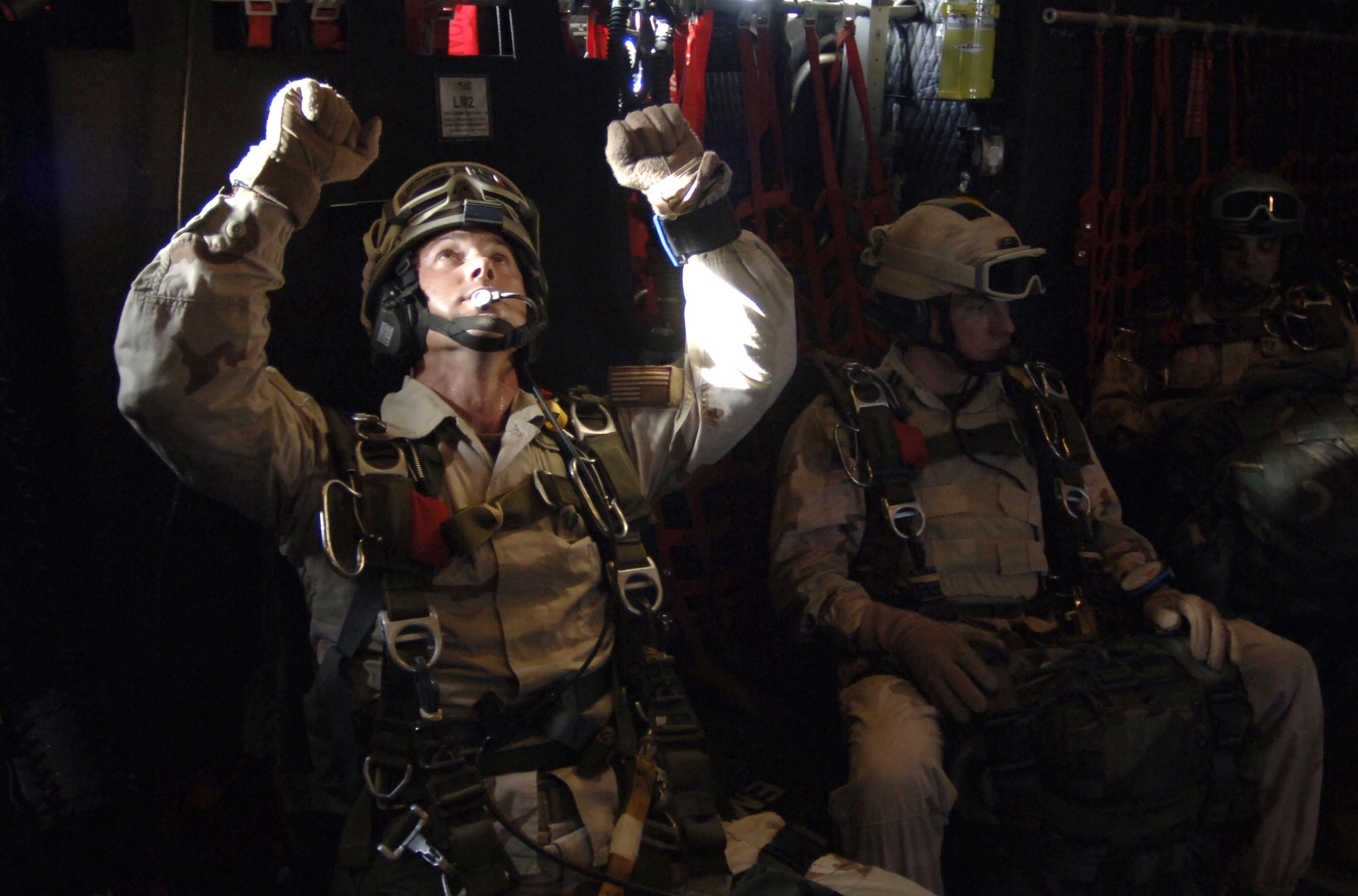 An Air Force pararescueman with the 304th Expeditionary Rescue Squadron  rehearses his parachute-opening procedures while waiting to make a high-altitude jump over the Gulf of Tadjoura in Djibouti, Africa, on Thursday, May 11, 2006. (U.S. Navy photo/Photographer's Mate 2nd Class Scott Taylor) 
