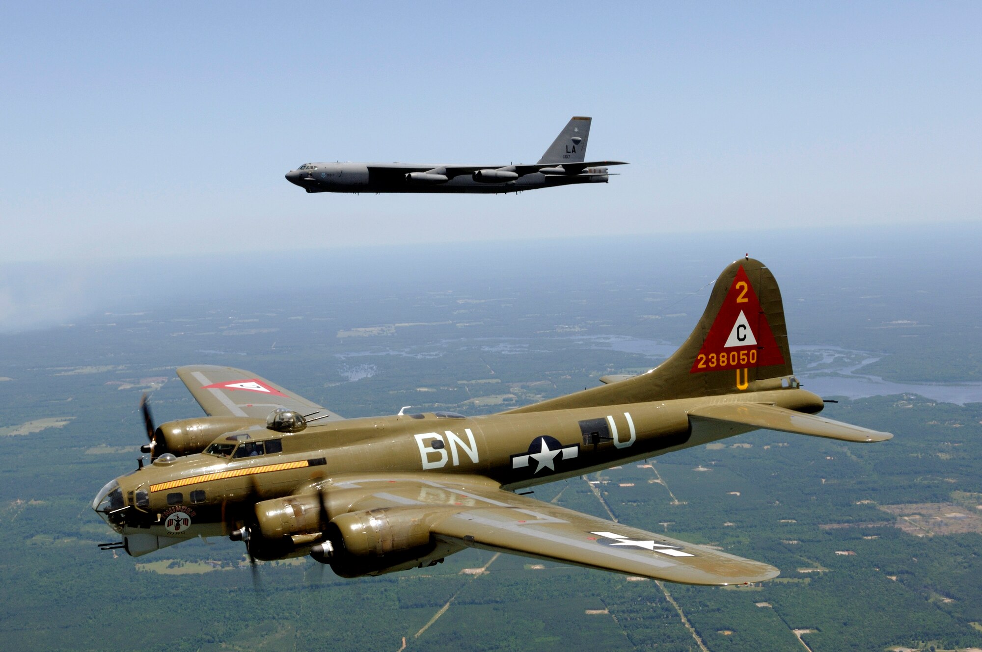 A B-17G Flying Fortress nicknamed "Thunderbird" participates in a heritage flight with a B-52H Stratofortress from the 2nd Bomb Wing. The 2006 Defenders of Liberty Airshow at Barksdale Air Force Base, La., kicked off May 12 with a twilight show. The B-17G is owned by the Lone Star Flight Museum in Galveston, Texas. (U.S. Air Force photo/Master Sgt. Michael A. Kaplan)