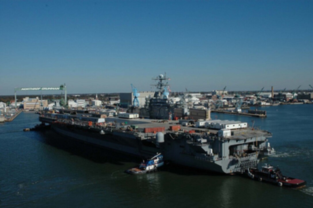 The USS Carl Vinson (CVN 70) is towed from pier 14 at Naval Station Norfolk.