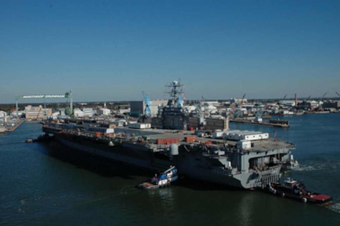 The Nimitz-class aircraft carrier USS Carl Vinson (CVN 70) is towed from pier 14 at Naval Station Norfolk, Va., to the Northrop Grumman Newport News Shipyard to begin the ship's refueling and complex overhaul on Nov. 11, 2005. During overhaul the Vinson will have nuclear fuel replenished and be upgraded with the latest technology enabling the ship to serve for many more years. 