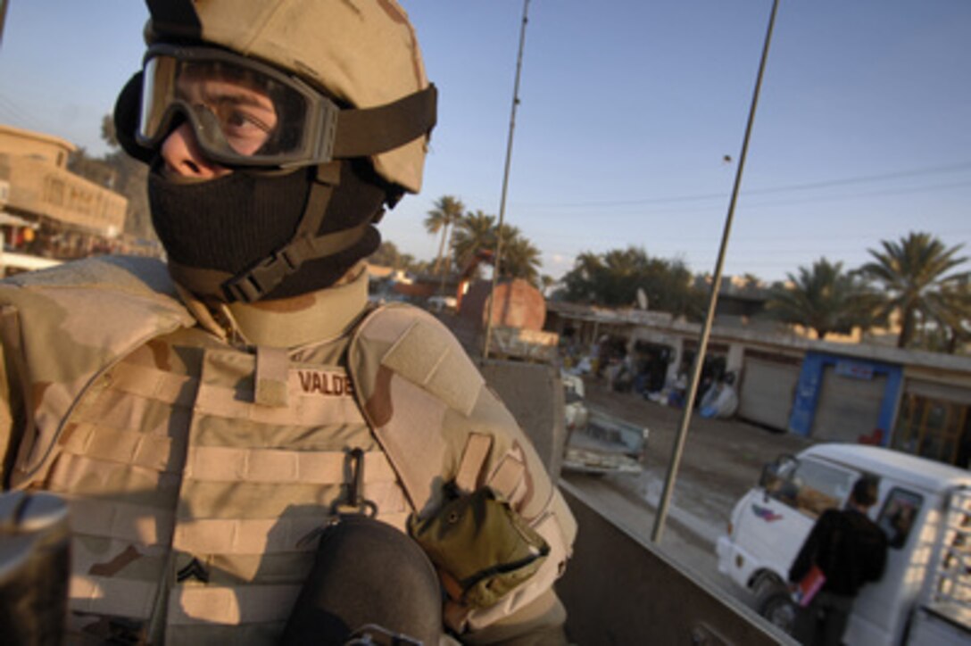 U.S. Army Cpl. Hector Valdez watches for any suspicious activity in the path of or around his Humvee convoy as he heads toward Anaconda, Iraq, on Jan. 15, 2006. Valdez is assigned as a gunner with Charlie Battery, 1st Battalion, 17th Field Artillery Regiment. 