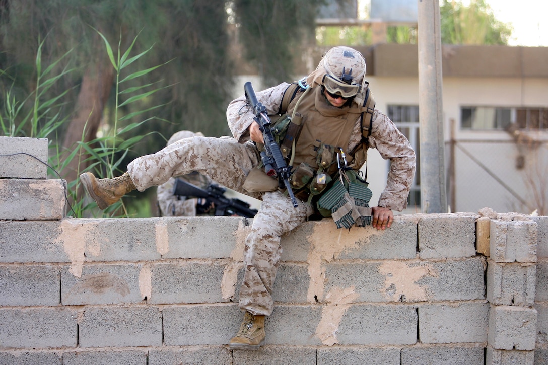 On 16 May 2006, Lance Corporal Sebastian M. Molnar, a 30-year-old assualtman with 3rd Platoon, K Company, 3rd Battalion, 8th Marine Regiment, scales a wall after a patrol in an area outside the Government Center. The operation was to conduct a battle damage assessment and to prevent Anti-Coalition Forces from staging attacks against Coalition Forces and Iraqi Security Forces in western Ramadi. 3/8 is currently deployed with I MEF (FWD) in support of Operation Iraqi Freedom in the Al Anbar province of Iraq (MNF-W) to develop the Iraqi Security Forces, facilitate the development of official rule of law through demographic government reforms, and continue the development of a market based economy centered on Iraqi reconstruction.