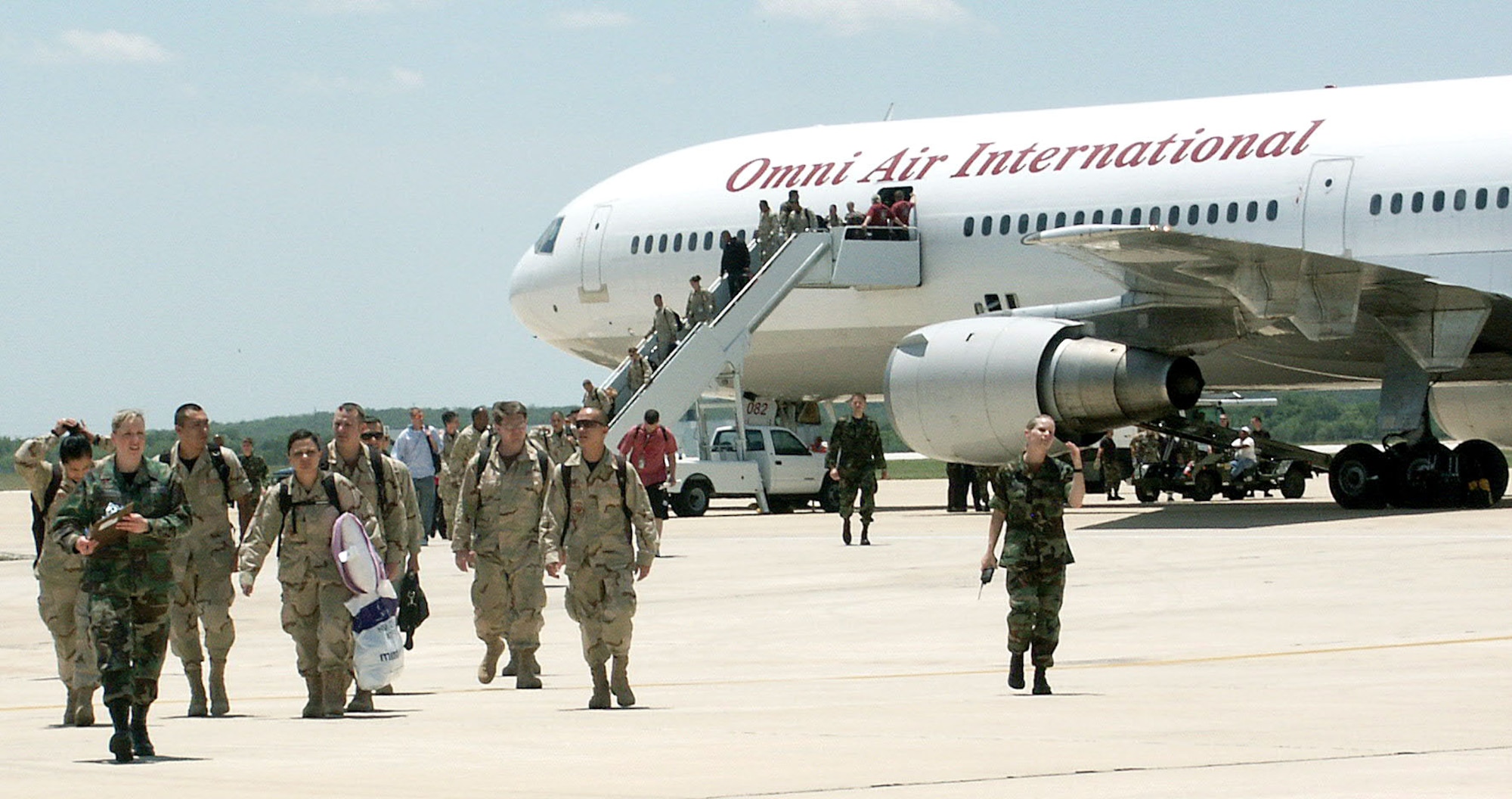 Members of the 59th Medical Wing arrive at Kelly Field in San Antonio after returning from a four-month deployment to Iraq on Tuesday, May 16, 2006. About 170 members of the Lackland wing deployed in January to work at the Air Force theater hospital at Balad Air Base. (U.S. Air Force photo/Sue Campbell) 
