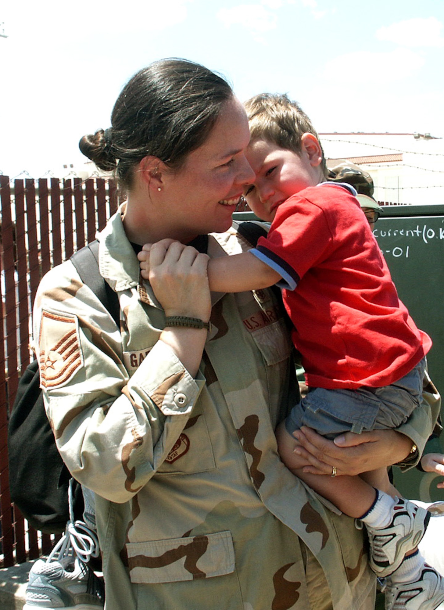 Master Sgt. Dawn Garza snuggles her son, Christopher, at the Kelly Field passenger terminal in San Antonio minutes after returning from a four-month deployment to Iraq on Tuesday, May 16, 2006. Sergeant Garza, a medical technician in the 859th Surgical Operations Squadron, was one of about 170 personnel from the 59th Medical Wing who deployed in January to work at the Air Force theater hospital at Balad Air Base. (U.S. Air Force photo/Sue Campbell) 
