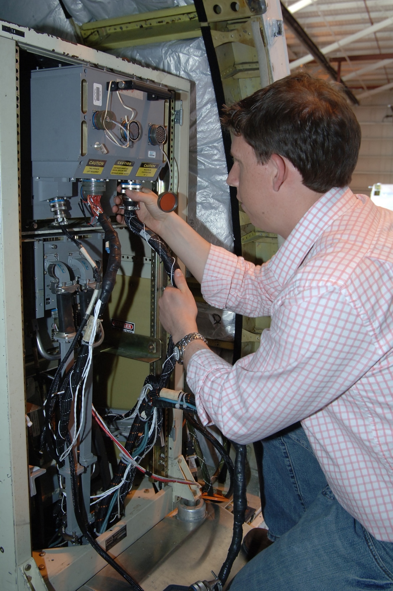 BALTIMORE - Andrew Peters, Flight Test Director at Northrop Grumman, installs the new Common Radar Processor on the BAC 1-1 1, Northrop Grumman's test bed aircraft located in Baltimore, Md.  Northrop Grumman is the subcontractor to the Boeing Company for the $180 million B-1 radar upgrade effort. (Northrop Grumman photo by Bobby West)

