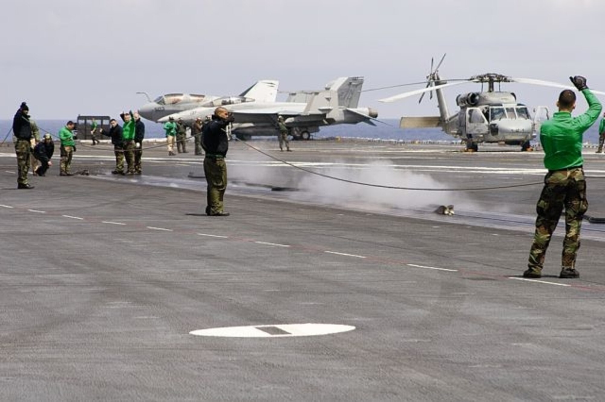 ABOARD USS STENNIS - U.S. Air Force Test Pilot School students build relations with Navy personnel during a day trip aboard the USS Stennis out of San Diego. The students watched repeated catches and catapults of aircraft while on the flight deck recently. (Air Force photo by Capt. Troy Welker)


