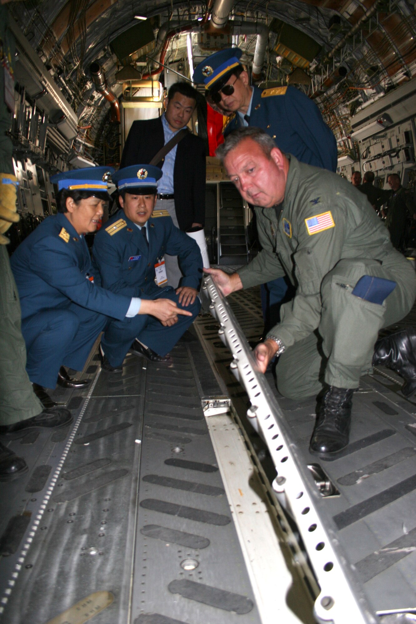 BERLIN, Germany - Col. Gary Cook, 315th Airlift Wing commander at Charleston Air Force Base, S.C., discuss the C-17's cargo load capabilities with Chinese Maj. Gen. Yue Xicui and Chinese Lt. Gen. Huang Xin at the Berlin Air Show May 16. Xicui is the Chinese Air Force's first female pilot and has more than 6,000 flying hours. The Chinese delegation also visited the B-1 Lancer and C-130J Hercules aircraft. Various models of U.S. military aircraft and about 60 support personnel from bases in Europe and the United States are attending the air show at Berlin-Schoenefeld Airport May 16-21. The Berlin Air Show is one of the premier events of its type in the world, and U.S. military participation contributes to a number of U.S. security and foreign policy interests. Participation promotes standardization and interoperability of equipment with our NATO allies and other potential coalition partners, highlights the strength of the U.S. commitment to the security of Europe and demonstrates that U.S. industry is producing equipment that will be critical to the success of current and future military operations.  (Photo by Maj. Pamela A.Q. Cook, USAF)
