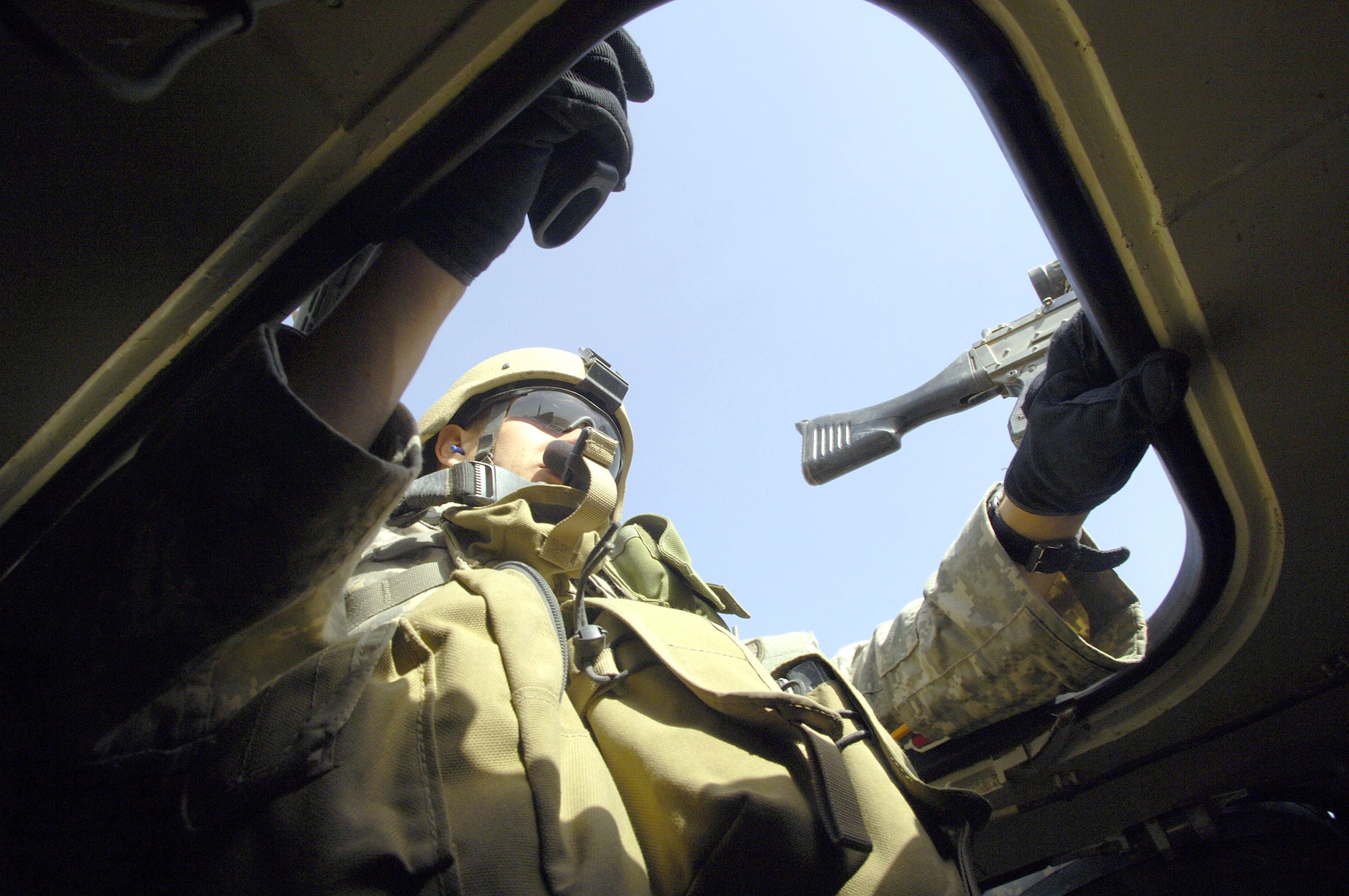 Staff Sgt. Chris Pierce provides rear security in a Stryker vehicle while on patrol near Sinjar, Iraq on May 14, 2006. Sergeant Pierce is a joint tactical air controller assigned to a U.S. Army Stryker brigade combat team. (U.S. Air Force photo/Staff Sgt. Jacob N. Bailey) 