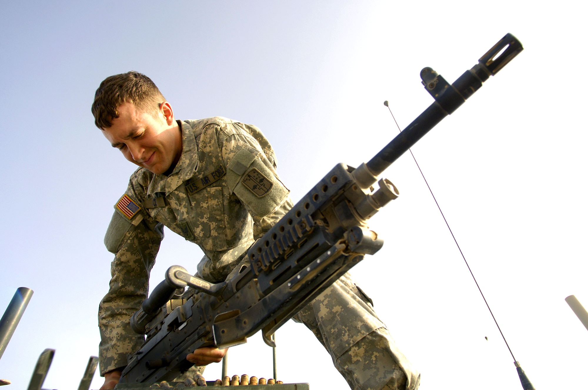 Staff Sgt. Chris Pierce mounts a M240 machine gun to the top of a Stryker vehicle before going on patrol near Sinjar, Iraq on May 14, 2006. Sergeant Pierce is a joint tactical air controller assigned to a U.S. Army Stryker brigade combat team. (U.S. Air Force photo/Staff Sgt. Jacob N. Bailey) 
