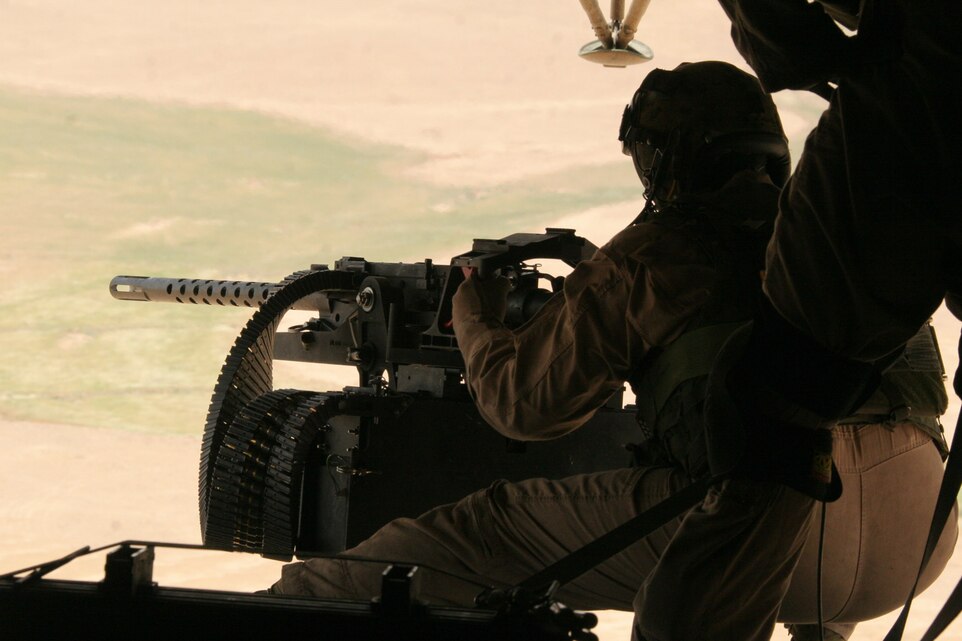 AL ASAD, Iraq - Cpl. Thomas D. Martinez aims at a makeshift target on the desert outside of Al Asad, Iraq May 16 during a test fire with the GAU-21 ramp-mounted weapon system. Martinez is a crew chief and weapons and tactics instructor with Marine Heavy Helicopter Squadron 463, Marine Aircraft Group 16 (Reinforced), 3rd Marine Aircraft Wing. He is a 22-year-old native of Durango, Colo.