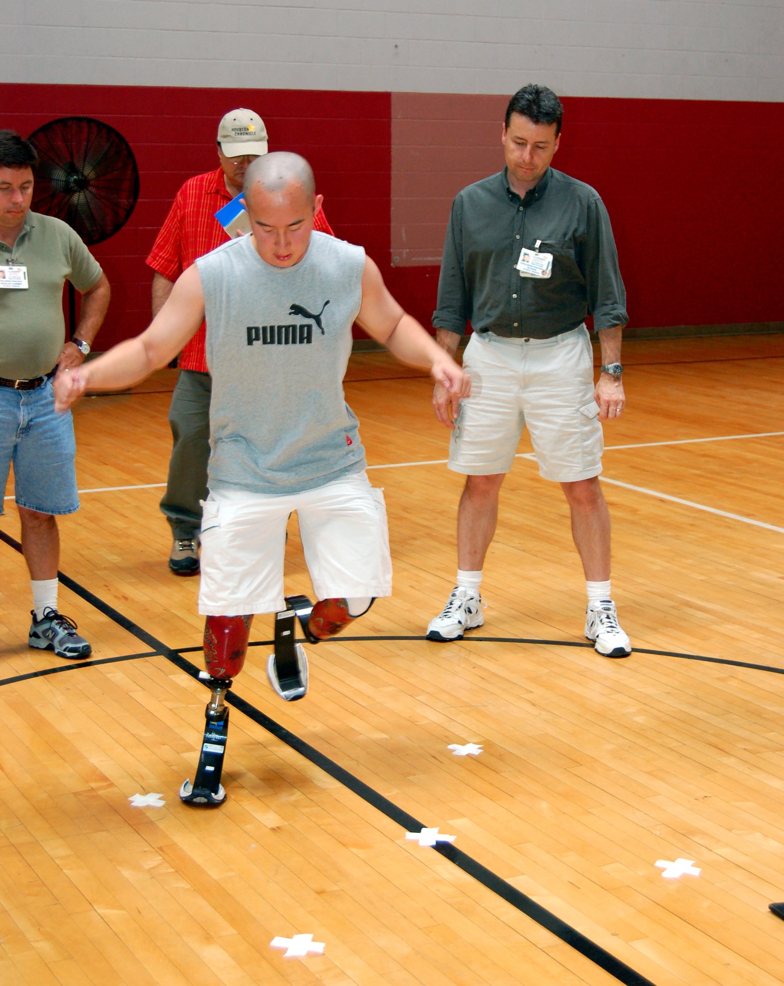 Retired Army Sgt. Chang Wong demonstrates a balance and agility exercise for Veterans Affairs therapists and prosthetists during a military amputee advance skills training workshop at the Jimmy Brought Fitness Center on Fort Sam Houston, Texas, on May 12, 2006. The Brooke Army Medical Center hosted the workshop to train VA therapists in the needs of today's military amputees. (U.S Air Force photo/Staff Sgt. Shad Eidson)