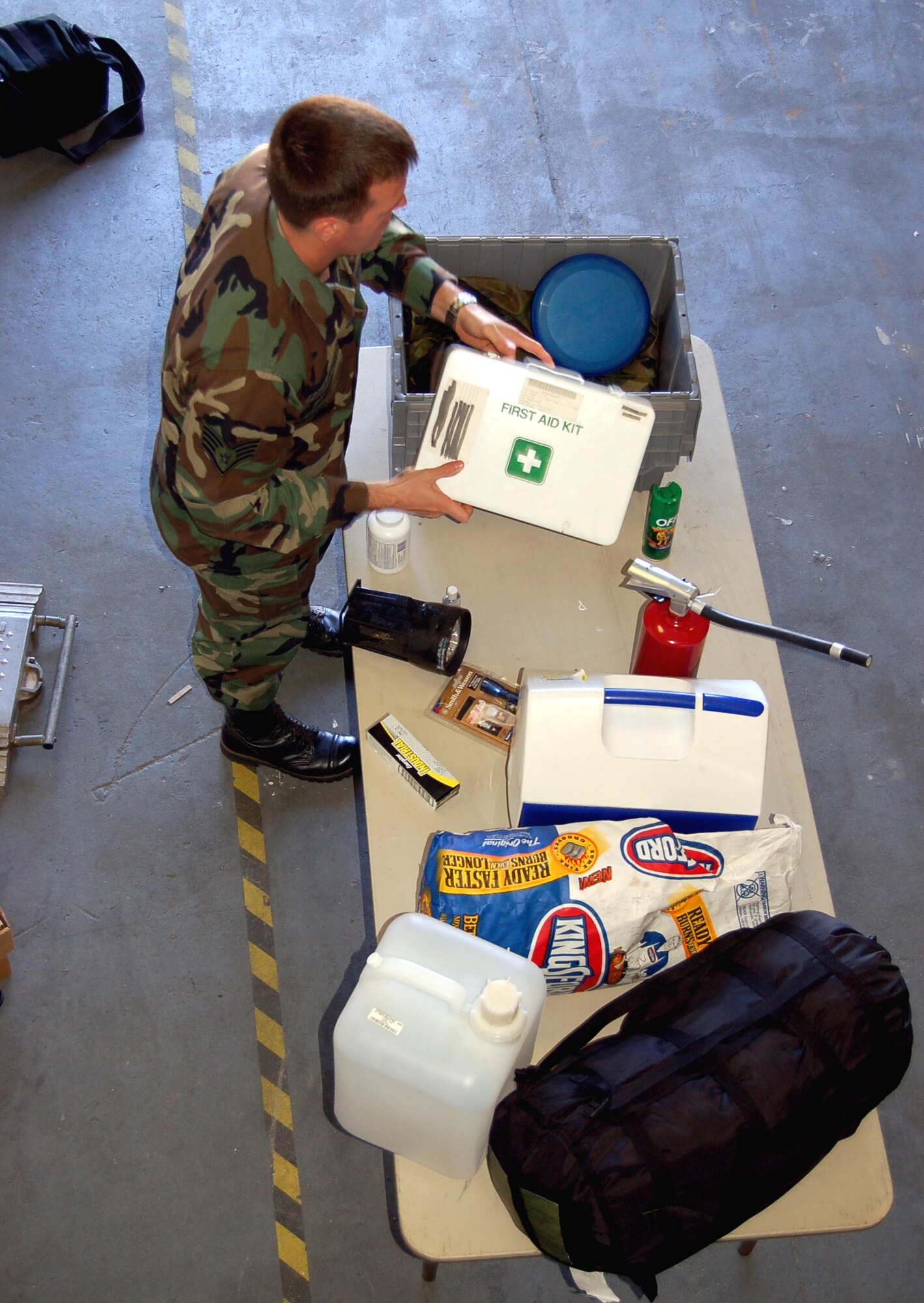 Staff Sgt. Darren Pemberton packs a "shelter in place kit" with items that will come in handy for those who have to evacuate or take shelter during a hurricane at Eglin Air Force Base, Fla., on Wednesday, May 17, 2006. He is a member of the 96th Civil Engineer Squadron readiness flight. With hurricane season right around the corner, from June through November, Eglin held a three-day exercise May 15 through May 17, called "Hurricane Lisette," to prepare for the next big storm. (U.S. Air Force photo/Master Sgt. Timothy P. Barela)