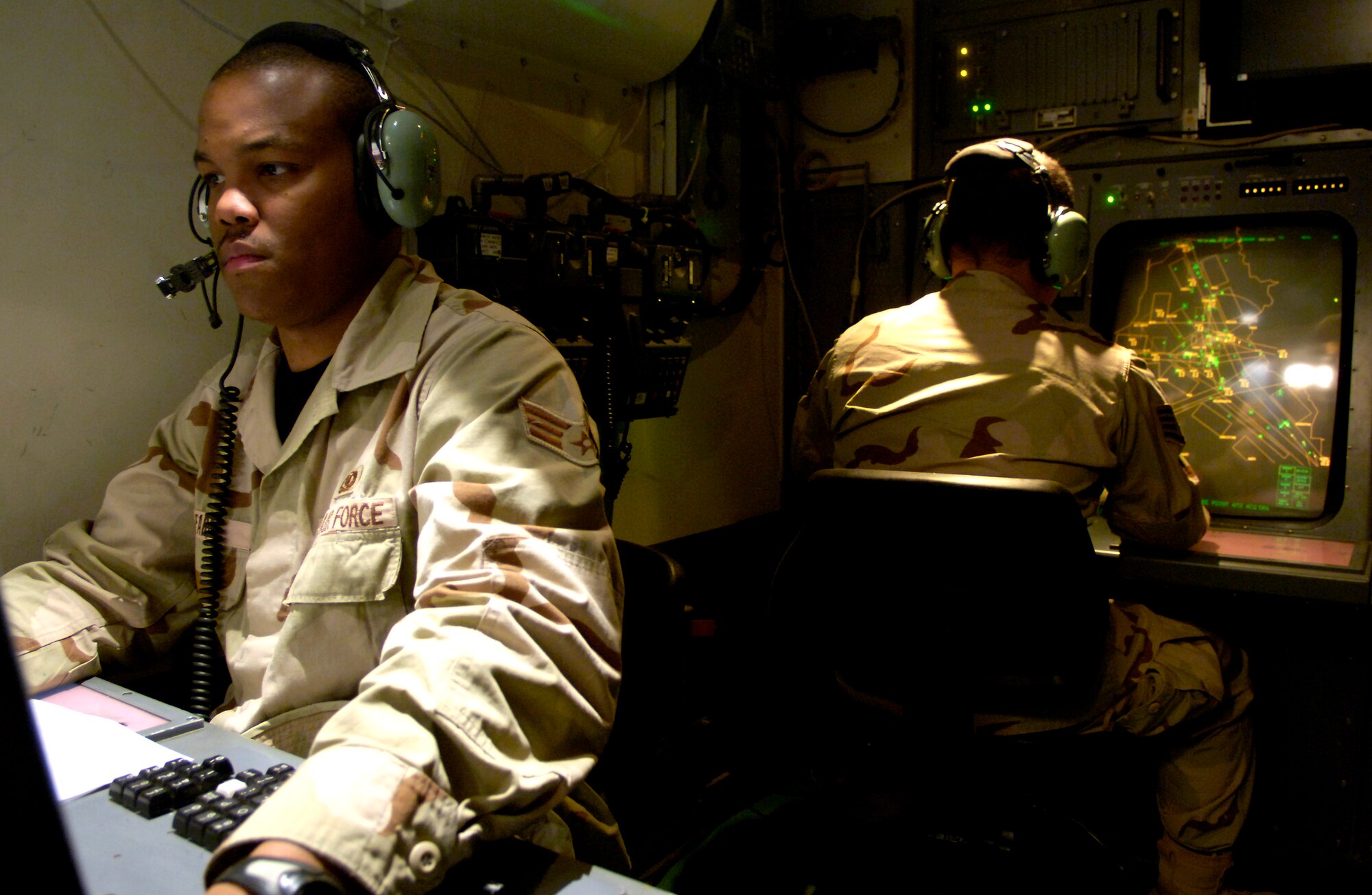 Senior Airman Derrick Farr performs surveillance and identification procedures with aircraft flying in the vicinity of Balad Air Base, Iraq, on May 15, 2006.  Controllers here monitor more than 200,000 square miles of air space.  The airfield is the busiest single-runway airfield in the Department of Defense.  Airman Farr is an air traffic controller with the 332nd Expeditionary Operation Support Squadron and is an Air National Guardsman deployed here from Savannah, Ga. (U.S. Air Force photo/Senior Airman Brian Ferguson) 