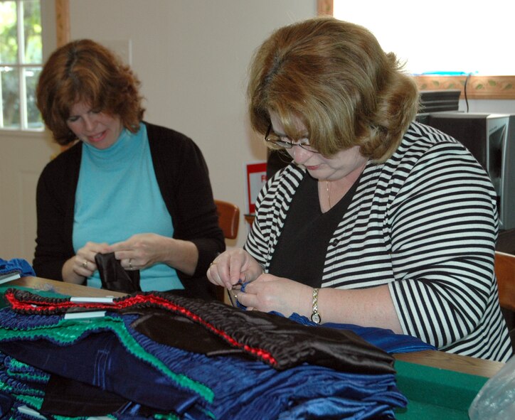 Elizabeth Jones, left, spouse of Lt. Col Kurt Jones, 709th Airlift Squadron, and Tanya Rutland, founder of the 512th Airlift Wing Spouses Group and wife of 512th Airlift Wing Commander Col. Ronald A. Rutland, spent May 15 ripping the seams out of shorts and sewing in Velcro and snaps to make it easier for injured servicemembers to slip on the shorts over medical devices such as braces and fixators.  The project is part of Sew Much Comfort, a non-profit organization that provides adapted clothing to seriously injured servicemembers who have fought in the war on terror.

