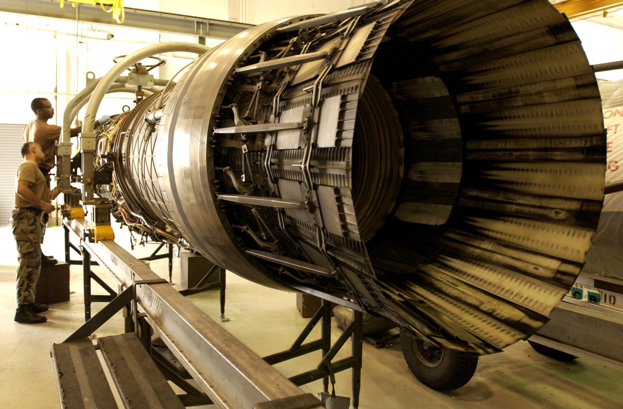 Staff Sgt. Edwin Quinones (front) and Senior Airman Michael Nathan repair an F-15 Eagle engine on May 10, 2006 that was damaged by foreign object debris, known as FOD.  Sergeant Quinones and Airman Nathan are aerospace propulsion technicians at the Florida Air National Guard's 125th Fighter Wing in Jacksonville. (U.S. Air Force photo/Staff Sgt. Shelley Gill)