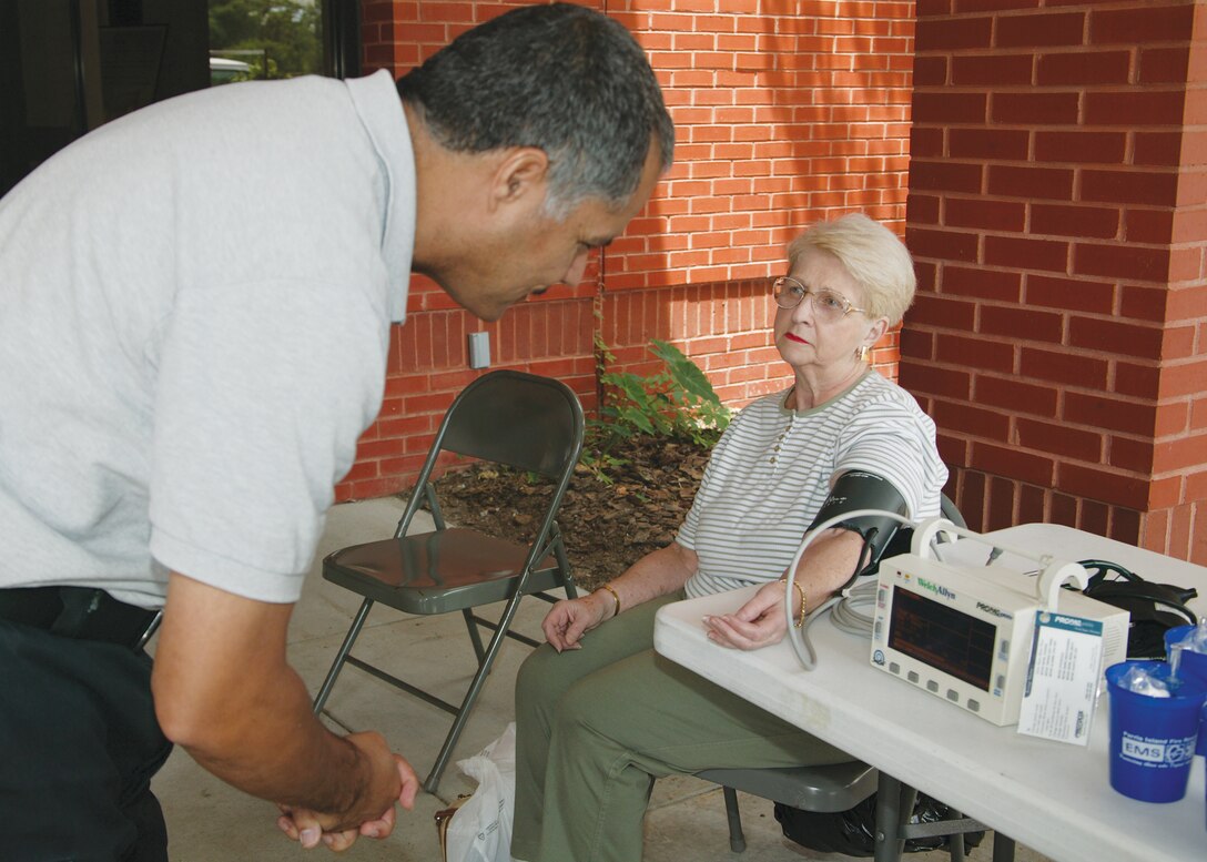 Diane Langford gets her blood pressure checked by the members of the Parris Island Fire Department before shopping at the Commissary Tuesday.  A group of firefighters and paremedics set up an Emergency Medical Services display to help spread awarness to shoppers about the dangers of high or low blood pressure and other health concerns.