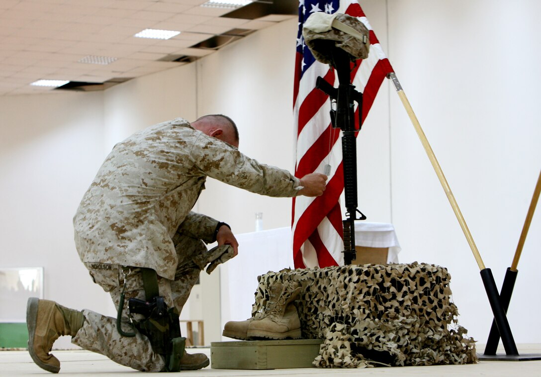 Colonel Larry D. Nicholson, the commanding officer of Regimental Combat Team 5, pays his last respects to Lance Cpl. Leon B. Deraps, a combat engineer with Company C, Combat Logistics Battalion 5, who was killed by an improvised explosive device on May 6, 2006 while providing engineering support in the Al Anbar Province.  Deraps, a native of Jamestown, Mo., was considered a kind-hearted and caring friend, one who put everyone ahead of himself. His awards include the Purple Heat, National Defense Service Medal, the Global War on Terrorism Service Medal, and the Iraqi Campaign Medal.