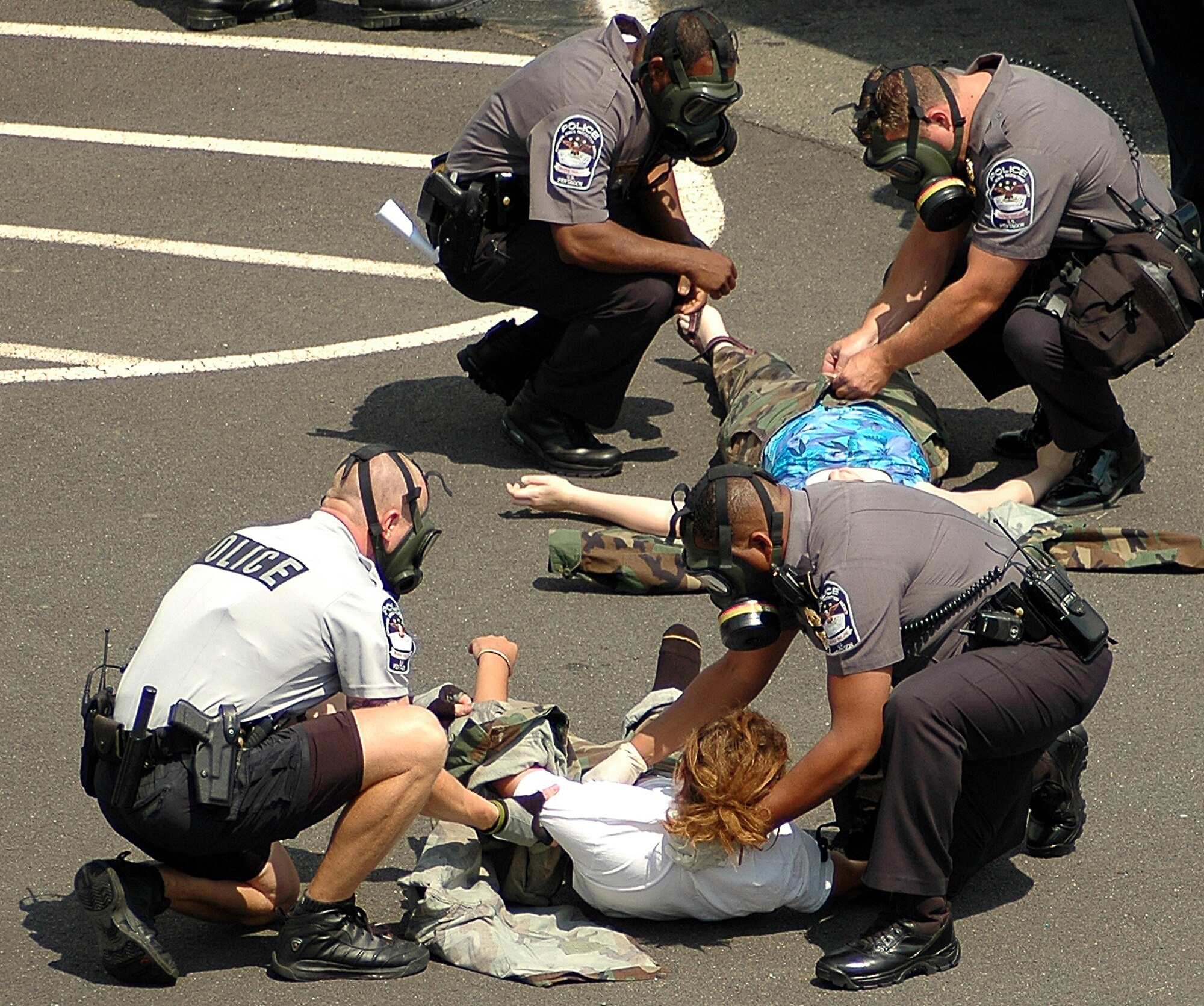 Members of the Pentagon Force Protection Agency help "victims" of an anthrax attack during an exercise at the Pentagon on Wednesday, May 17, 2006.  During exercise Gallant Fox 06, officials from Washington D.C. area fire, emergency medical service, and police departments; military members; and members of the Pentagon Force Protection Agency participated in the exercise, which included decontamination and medical processing of victims of a simulated anthrax attack at the Pentagon.  (U.S. Air Force photo/Staff Sgt. C. Todd Lopez)