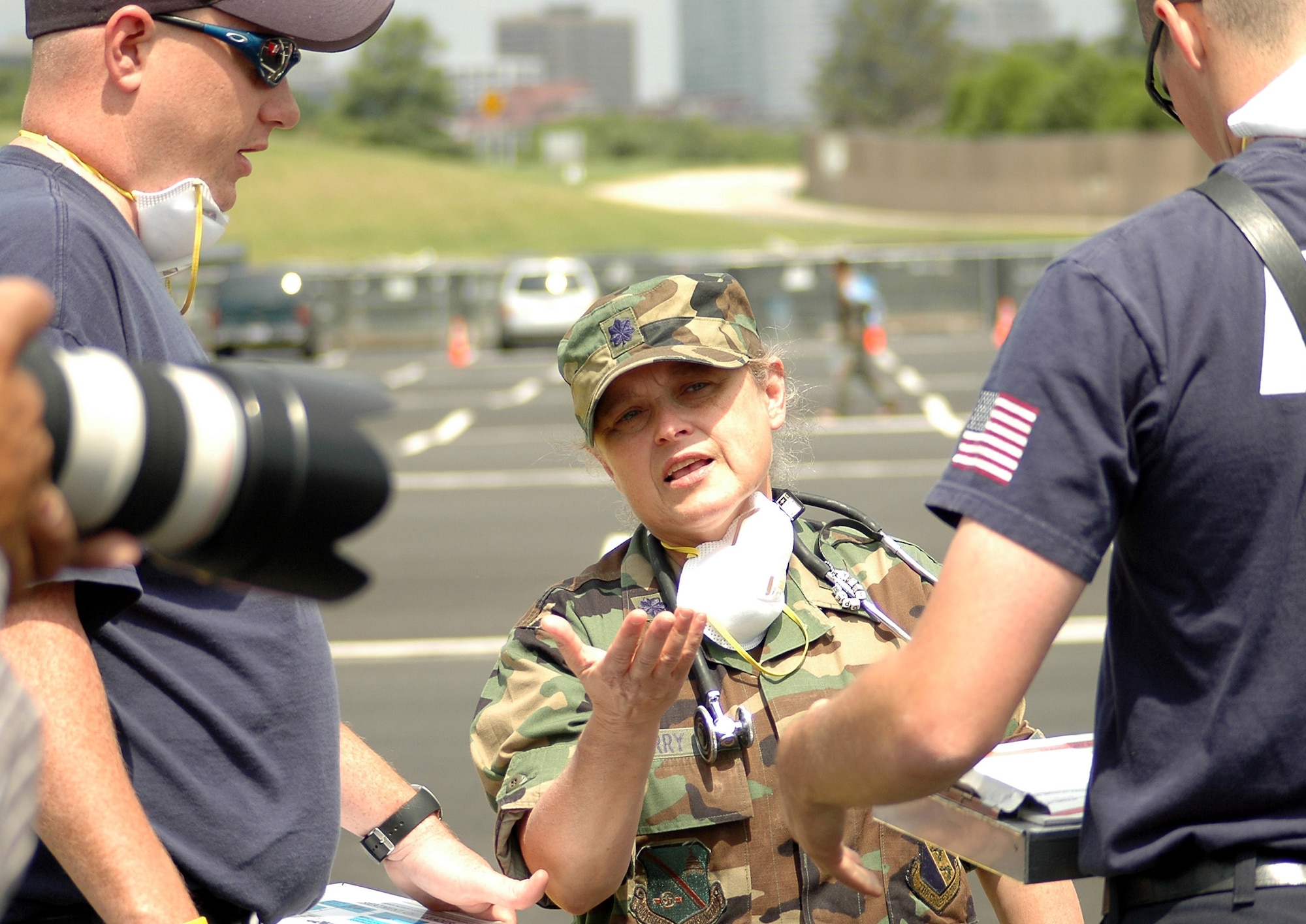 Lt. Col. (Dr.) Marilyn D. Perry speaks with members of the Arlington County Fire Department during an exercise at the Pentagon on Wednesday, May 17, 2006.  Dr. Perry acted as the on-scene medical director for the exercise.  During exercise Gallant Fox 06, officials from Washington D.C. area fire, emergency medical service, and police departments; military members; and members of the Pentagon Force Protection Agency participated in the exercise, which included decontamination and medical processing of victims of a simulated anthrax attack at the Pentagon.  (U.S. Air Force photo/Staff Sgt. C. Todd Lopez)