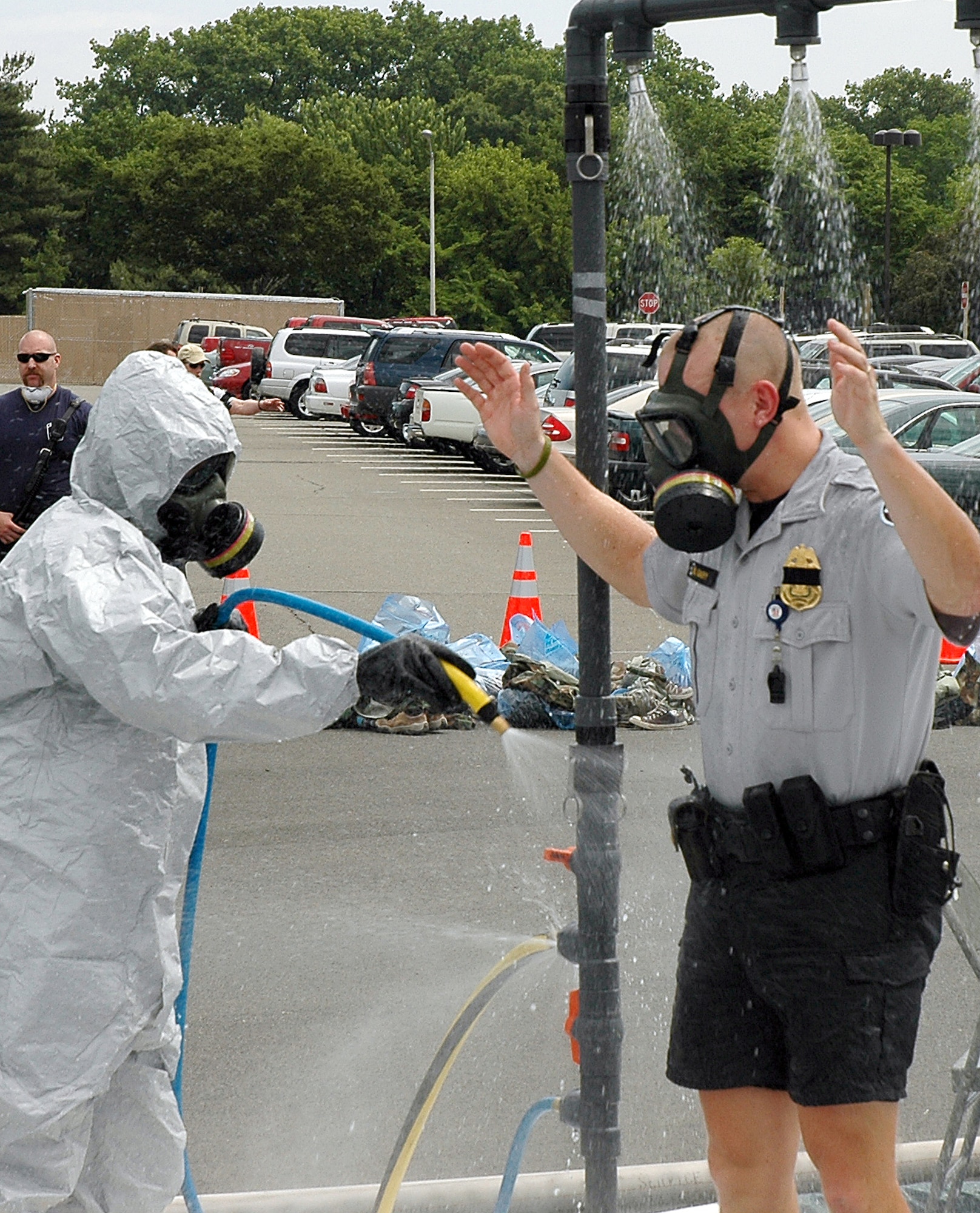 A member of the Pentagon Force Protection Agency is decontaminated during an exercise at the Pentagon on Wednesday, May 17, 2006.  During exercise Gallant Fox 06, officials from Washington D.C. area fire, emergency medical service, and police departments; military members; and members of the Pentagon Force Protection Agency participated in the exercise, which included decontamination and medical processing of victims of a simulated anthrax attack at the Pentagon.  (U.S. Air Force photo/Staff Sgt. C. Todd Lopez) 