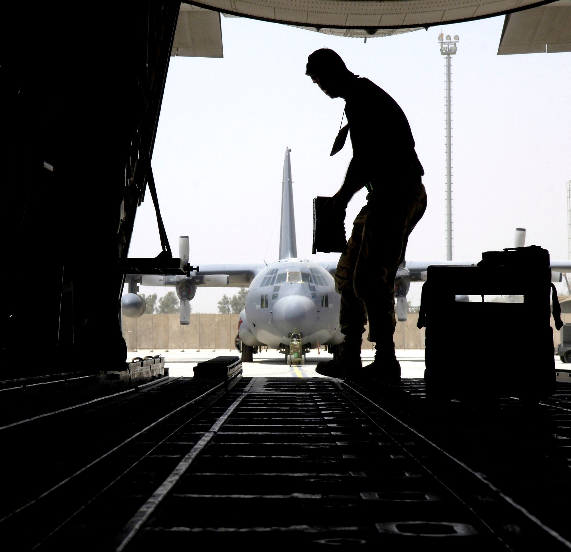 Tech. Sgt. Sean Fox changes the cargo roller configuration on a C-130 Hercules at Balad Air Base, Iraq, on May 16, 2006. Sergeant Fox is a maintainer in the 777th Expeditionary Aircraft Squadron deployed from Little Rock Air Force Base, Ark.. The airfield is the busiest single-runway airfield in the Department of Defense. Since January 2006, the squadron's active-duty, Guard and Reserve Airmen have launched more than 3,700 sorties that carried some 54,200 people and 11,790 tons of cargo. (U.S. Air Force photo/Senior Airman Brian Ferguson) 

