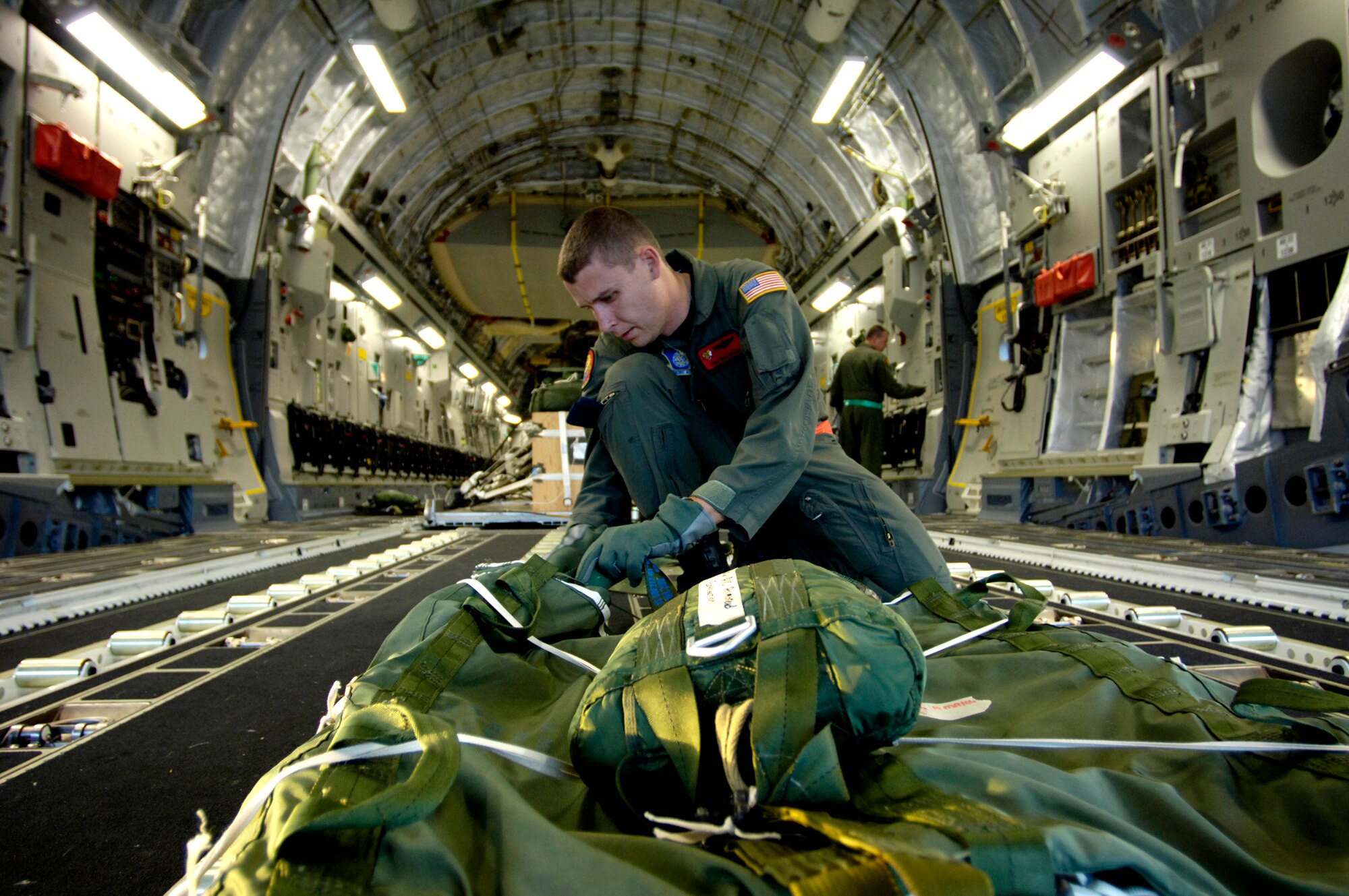 Tech. Sgt. Ken Bragg inspects and prepares an extraction chute on his C-17 Globemaster III for an upcoming airdrop training mission May 16, 2006, at Hickam Air Force Base, Hawaii. Sergeant Bragg is a loadmaster from the 535th Airlift Squadron. The training provides multi-element training for the pilots enables users to get larger amounts of equipment in a short period of time and maintains aircrew proficiency. (U.S. Air Force photo/Tech. Sgt. Shane A. Cuomo) 
