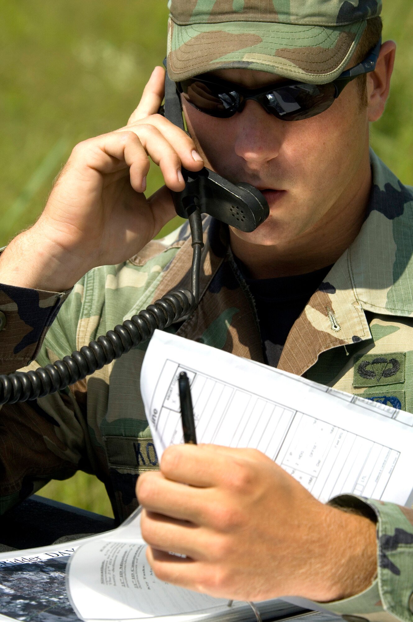 Staff Sgt Daniel Kovarik, a joint terminal air controller assigned to Detachment 1, 458th Combat Training Squadron, Fort Polk, La., calls in targeting coordinates of a suspected terrorist hideout to nearby A-10 Thunderbolt IIs during urban combat air support training on May 16, 2006.  The training took place in Deridder, La., where the 458th CTS has an agreement to allow flights over the city for more realistic urban conditions.  (U.S. Air Force Photo/Master Sgt. Jack Braden