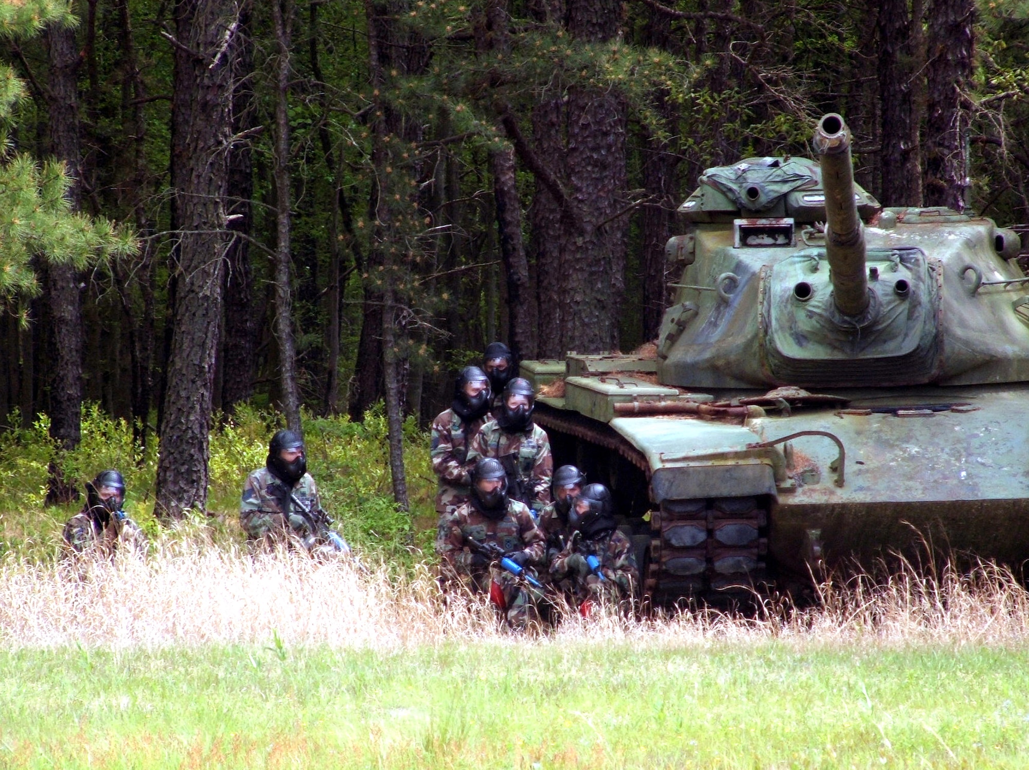 Phoenix Raven course students duck behind cover during use-of-force training here May 17, 2006, at Fort Dix, N.J.  Raven students, who include Air Force security forces, Navy masters at arms and Army military police, train in combat first aid, tactical self defense and aircraft security.  The course is taught by instructors from the Air Mobility Warfare Center's 421st Combat Training Squadron. (U.S. Air Force Photo/Tech. Sgt. Scott T. Sturkol)