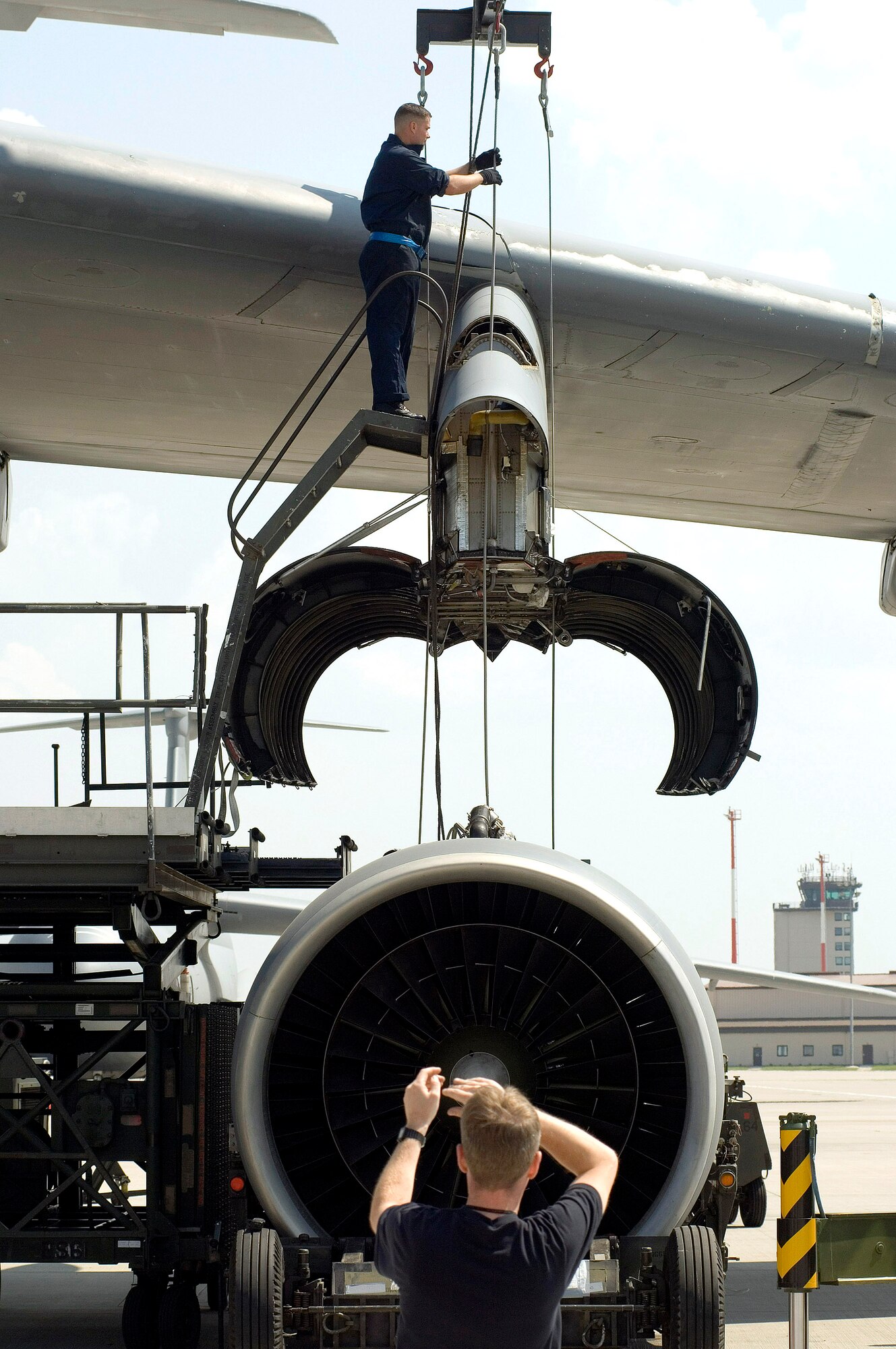 Staff Sgt. Sean Donovan (top) centers cables while preparing to mount an engine on a C-5 Galaxy on May 12, 2006, at Ramstein Air Base Germany.  Sergeant Donovan is a jet engine mechanic assigned to the 723rd Air Mobility Squadron. (U.S. Air Force photo/Master Sgt. John E. Lasky) 