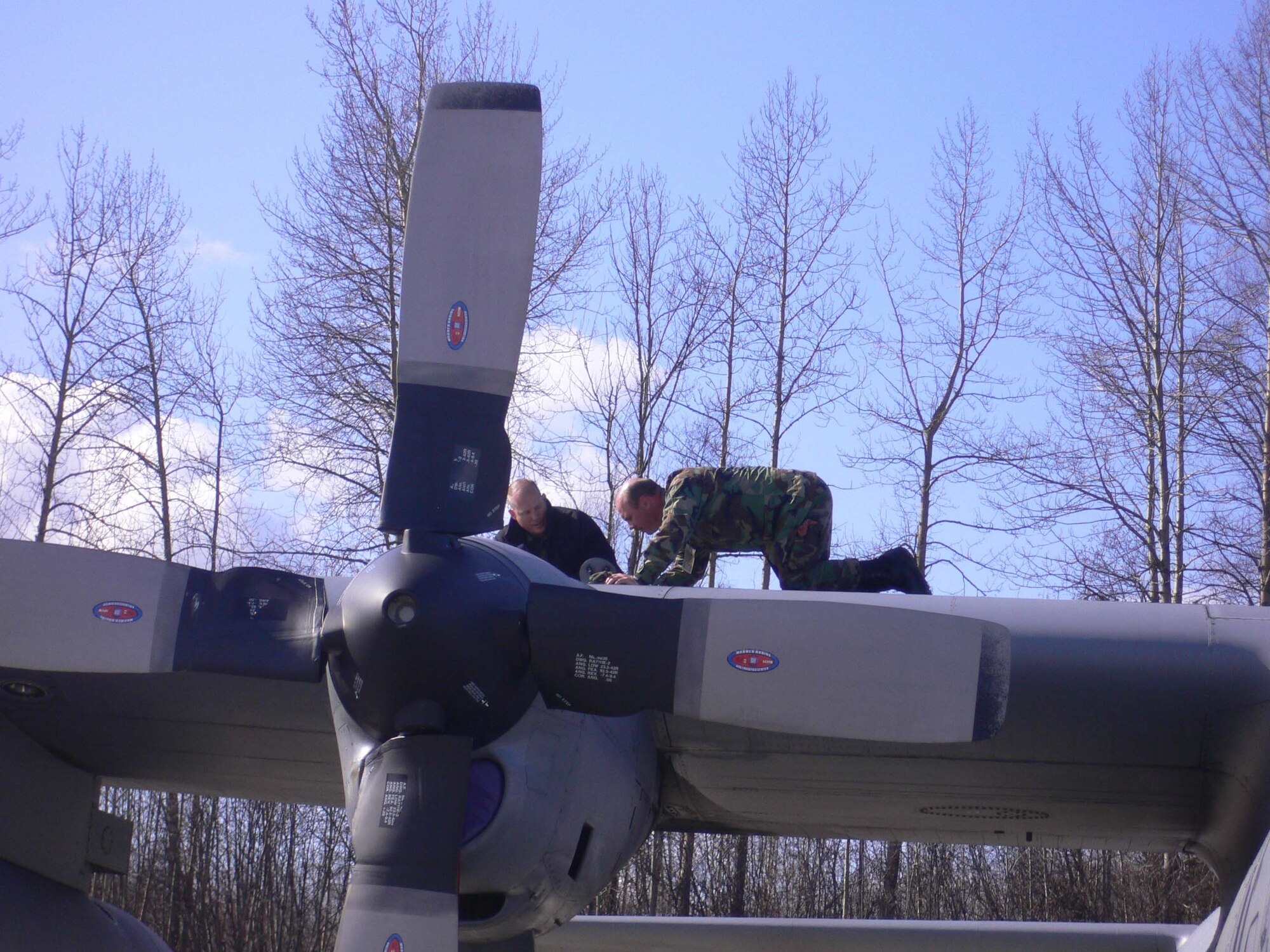 Tech. Sgt. John Sadlovsky (left)and Tech Sgt. Dave Fisher inspect a C-130 before flight.
