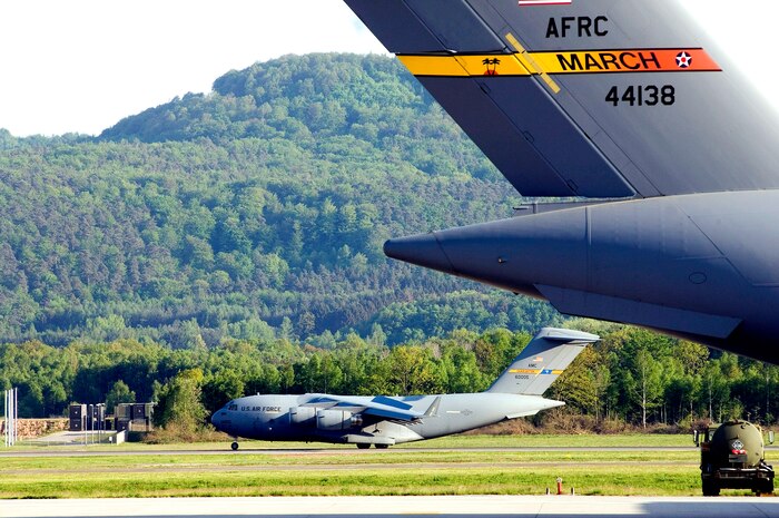 A C-17 Globemaster III from the 437th Airlift Wing at Charleston Air Force Base, S.C., lands at Ramstein Air Base, Germany, on May 11, 2006.  The C-17 in the foreground is from the Air Force Reserve Command's 452nd Air Mobility Wing at March Air Reserve Base, Calif.  (U.S. Air Force photo/Master Sgt. John E. Lasky) 