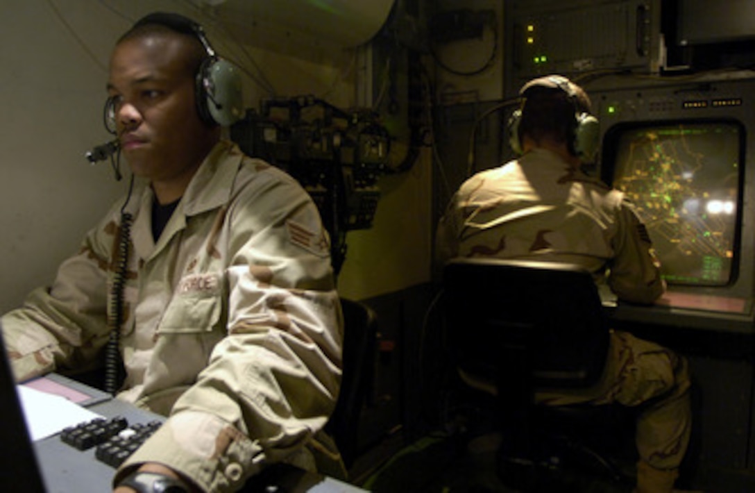 U.S. Air Force Senior Airman Derrick Farr (left) performs surveillance and identification procedures with the tactical air traffic in the skies over Iraq at Balad Air Base on May 15, 2006. Farr is an Air National Guardsman deployed with 727th Expeditionary Air Control Squadron. 