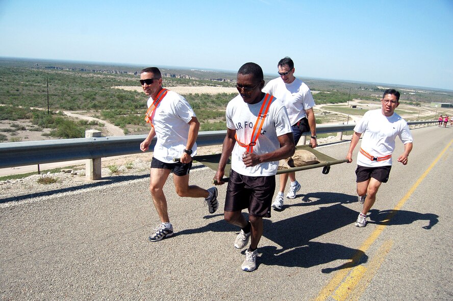 From left to right, Maj. Dan Pence, Senior Airman Olufemi Owolabi, Col. Mike Minahan, and Tech. Sgt. Gabriel Valdez compete as relay team 'XL1' in the "sandbag litter carry" portion of the 7-mile run leg in the 2006 Laughlin Adventure Race.  The third year for the race, it was begun by an instructor pilot at the base as a way to have fun but yet challenge one's self in physical competition.  Major Pence is the wing plans officer, Airman Owolabi works in the public affairs office,  Colonel Minahan is the wing commander and Sergeant Valdez is the wing command post operations NCOIC.  (U.S. Air Force photo/Senior Airman Austin M. May)