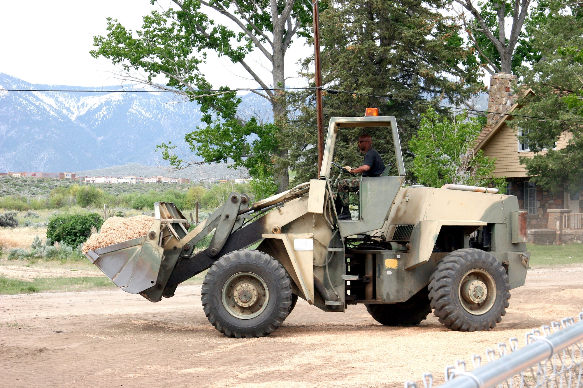 Master Sgt. Jon Conway moves bark chips into the playground at the tribal head start building on the Washoe Indian Reservation near Carson City, Nev. May 15, 2006. He is the first sergeant and utilities craftsman with the 939th Civil Engineering Squadron and one of 14 reservists deployed as part of an Air Force Reserve Command innovative readiness training program. (U.S. Air Force Photo/Ruby Zarzyczny)