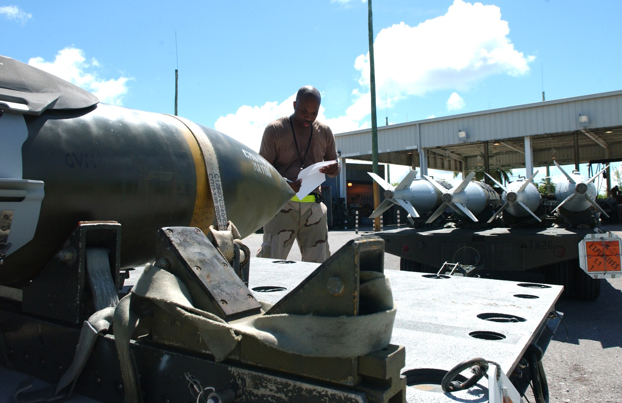 Tech. Sgt. Wilbert Terrell inspects a 2,000-pound bomb before doing a tear down and rebuild of the bomb at a base supporting Operating Enduring Freedom on Wednesday, May 17, 2006. The Airman, of the 40th Air Expeditionary Group, deployed here from Barksdale Air Force Base. (U.S. Air Force photo/Staff Sgt. Patrick Mitchell) 