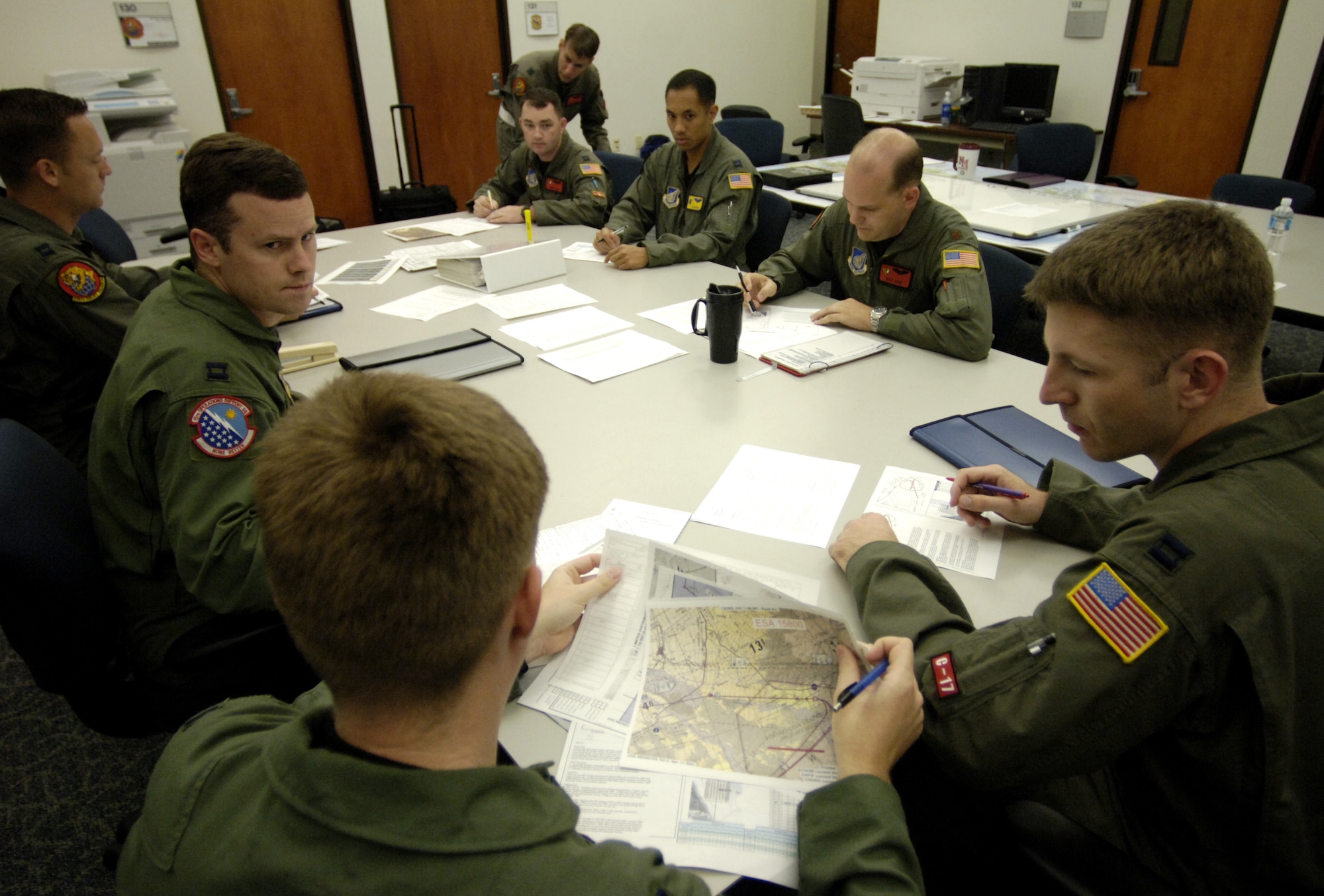 C-17 Globemaster III pilots conduct a pre flight briefing May 16, 2006 before flying a 4-ship airdrop training mission. The pilots are from the 535th Airlift Squadron, Hickam Air Force Base, Hawaii. The 4-ship training provides multi-element training for the pilots enables users to get larger amounts of equipment in a short period of time and maintains aircrew proficiency. (U.S. Air Force photo by Tech. Sgt. Shane A. Cuomo) 