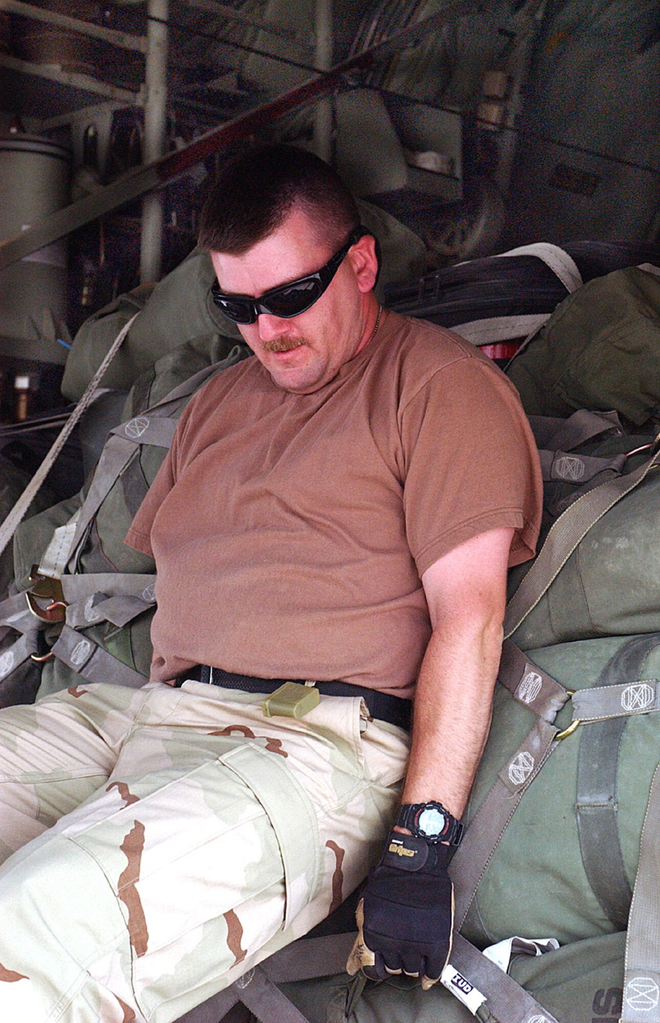 Staff Sgt Joe Lankford pushes a baggage pallet onto a C-130 Hercules on the ramp at Ali Base, Iraq.  Sergeant Lankford works in the Air Terminal Operations Center and is assigned to the 407th Expeditionary Logistics Readiness Squadron.  (U.S. Air Force photo/by Master Sgt. Andrew Gates) 