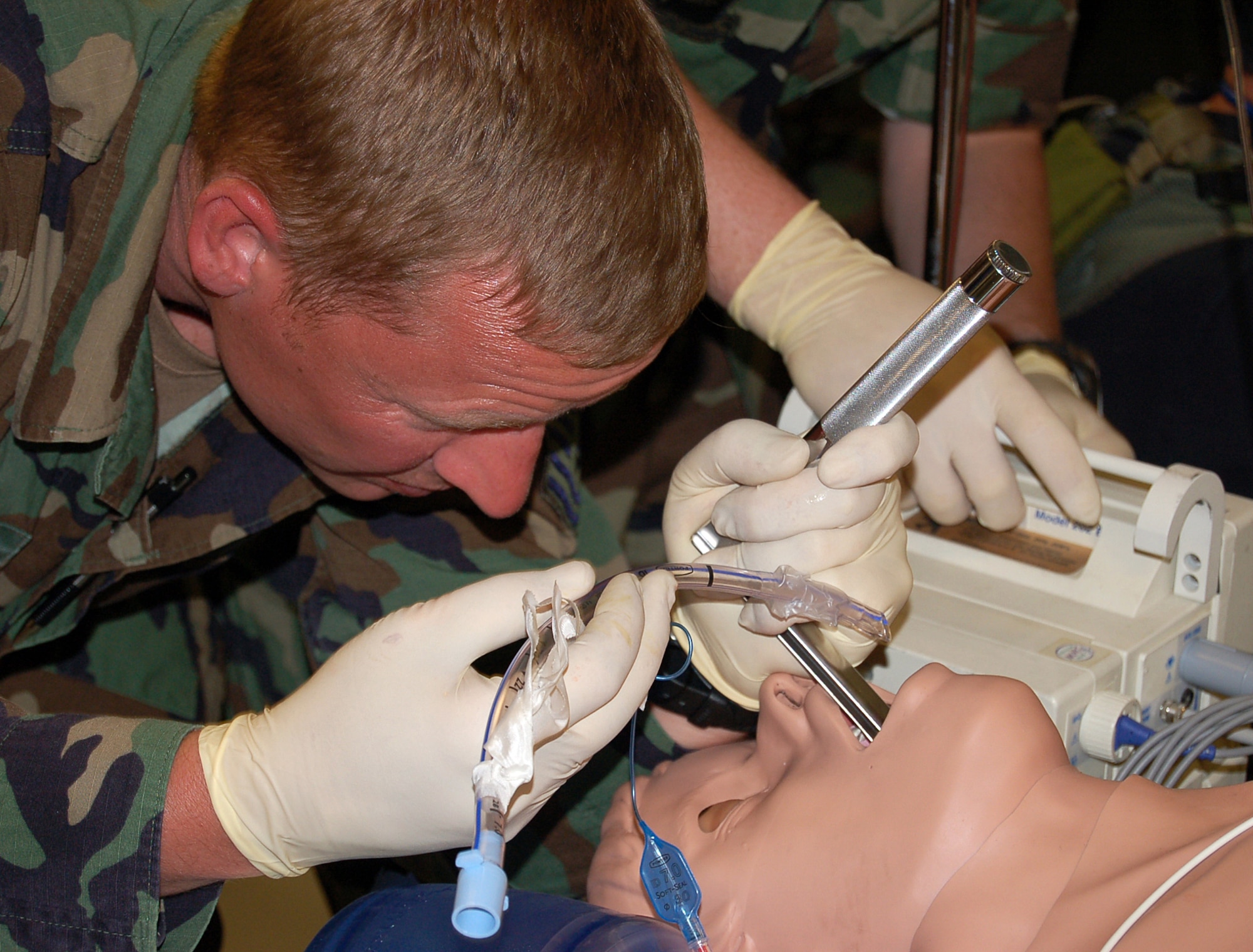 Tech. Sgt. Jared Schultz demonstrates to students how to secure an airway on a computerized mannequin on Thursday, May 18, 2006, during a new Air Force Special Operations Command casualty evacuation course.  The realistic training is geared to better prepare medics for the chaos of combat operations.  Sergeant Schultz is an independent duty medical technician and casualty evacuation course instructor with AFSOC.  (U.S. Air Force photo/Master Sgt. Timothy P. Barela) 