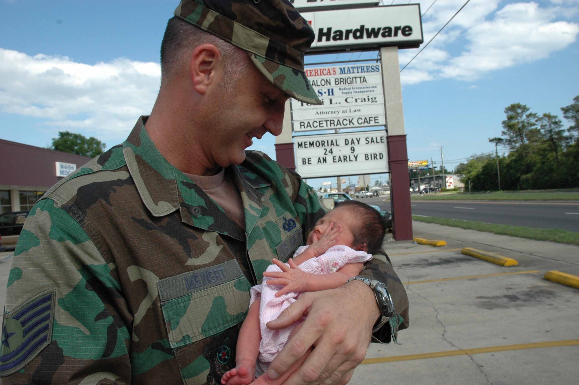 EGLIN AIR FORCE BASE, Fla. —Tech. Sgt. Greg Meinert, 9th Special Operations Squadron, holds Isabella in the parking lot where he delivered her May 10. (Air Force photo by Maranda Rimes)