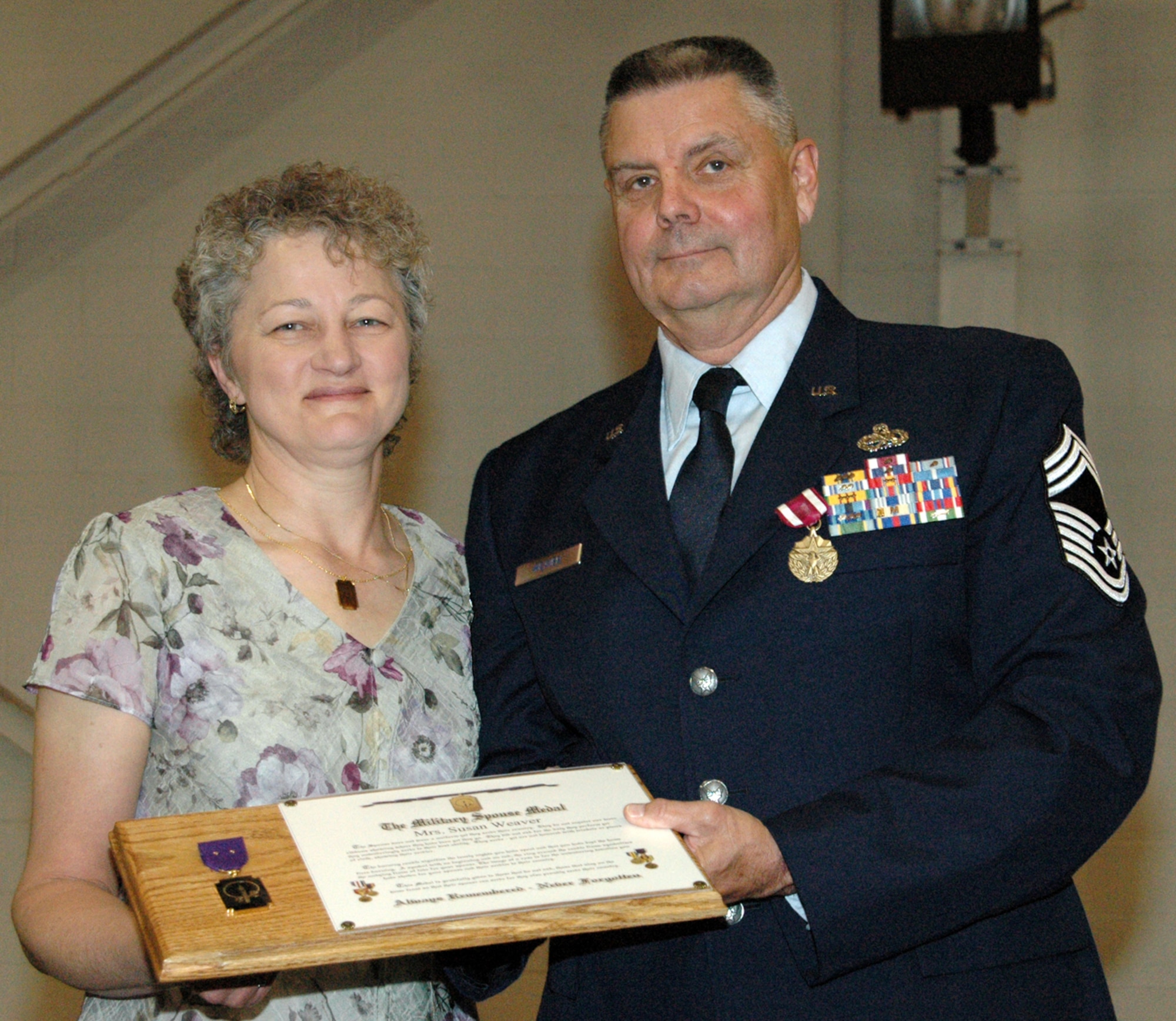 YOUNGSTOWN AIR RESERVE STATION, Ohio - Air Force Reserve Chief Master Sgt. David L. Weaver presented his wife Sue a Military Spouse Medal at his retirement ceremony May 6 in recognition of her continued support of the Chief's military career.  Chief Weaver's career spanned nearly 40 years with the Air Force and Air Force Reserve.  (U.S. Air Force photo/Master Sgt. Bryan Ripple)