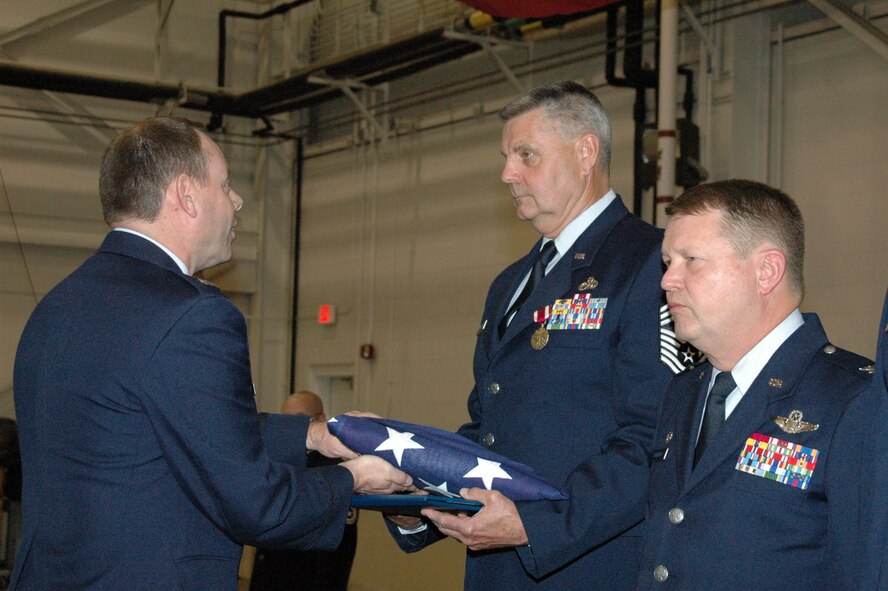 YOUNGSTOWN AIR RESERVE STATION, Ohio - Air Force Reserve Chief Master Sgt. David L. Weaver, superintendent of the 910th Maintenance Squadron, receives a United States flag from Capt. Brad Forrider, officer in charge of the 910th Honor Guard, during the Chief's retirement ceremony May 6 after nearly 40 years of service with the Air Force and Air Force Reserve.  (U.S. Air Force photo/Master Sgt. Bryan Ripple)