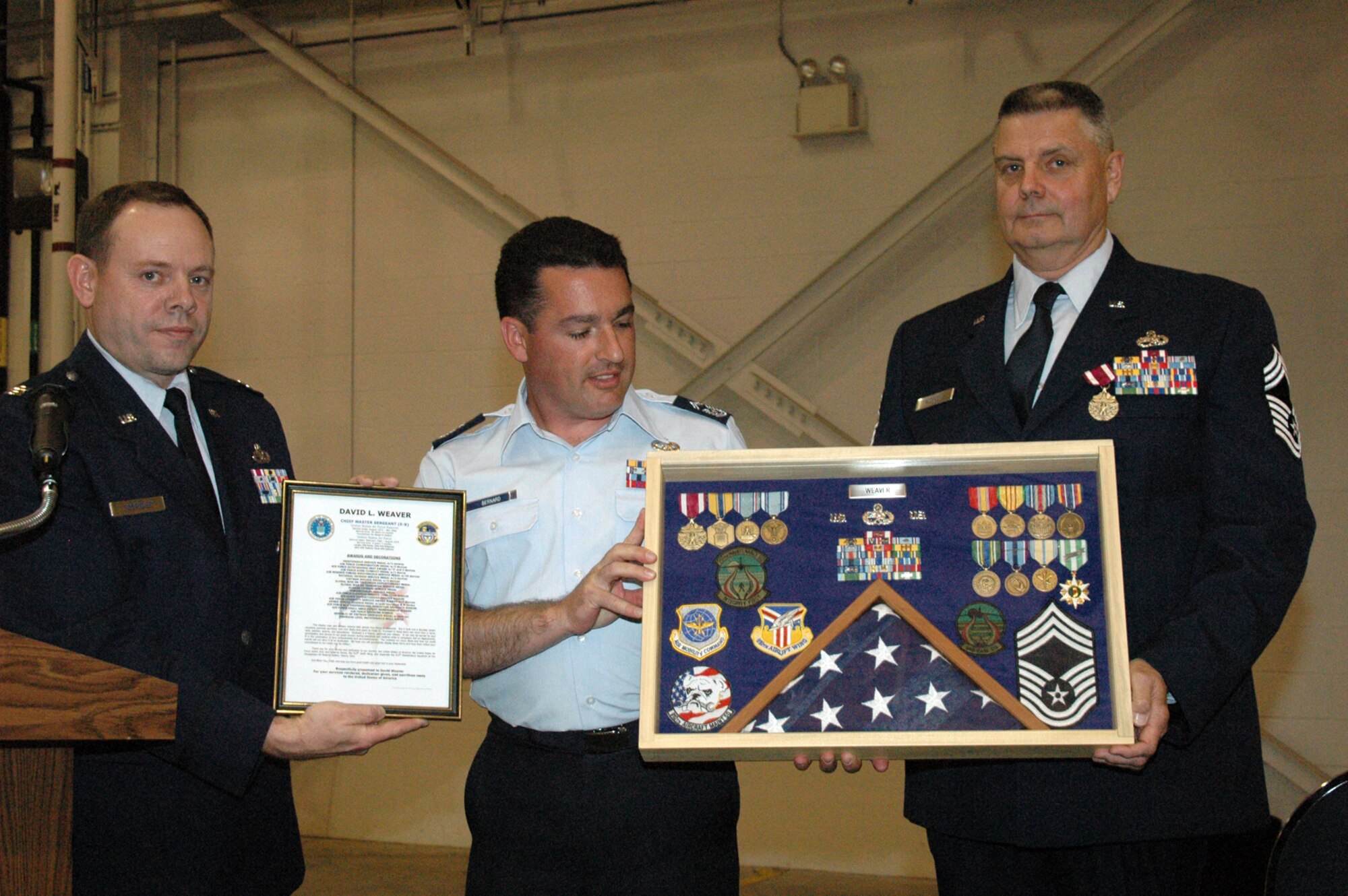 YOUNGSTOWN AIR RESERVE STATION, Ohio - Air Force Reserve Chief Master Sgt. David L. Weaver, superintendent of the 910th Maintenance Squadron, retired from the Air Force Reserve May 6 after nearly 40 years of service with the Air Force and Air Force Reserve. Here Capt. Brad Forrider, commander of the 910th Maintenance Squadron, and SMSgt. Doug Bernard, B Flight Chief of the 910th Aircraft Maintenance Squadron, present Chief Weaver with a traditional military shadow box honoring his years of service. (U.S. Air Force photo/Master Sgt. Bryan Ripple)