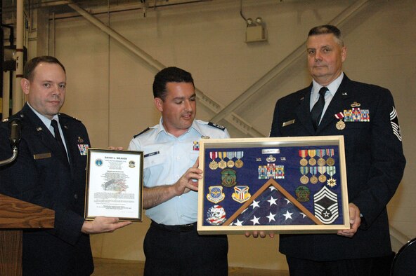 YOUNGSTOWN AIR RESERVE STATION, Ohio - Air Force Reserve Chief Master Sgt. David L. Weaver, superintendent of the 910th Maintenance Squadron, retired from the Air Force Reserve May 6 after nearly 40 years of service with the Air Force and Air Force Reserve. Here Capt. Brad Forrider, commander of the 910th Maintenance Squadron, and SMSgt. Doug Bernard, B Flight Chief of the 910th Aircraft Maintenance Squadron, present Chief Weaver with a traditional military shadow box honoring his years of service. (U.S. Air Force photo/Master Sgt. Bryan Ripple)