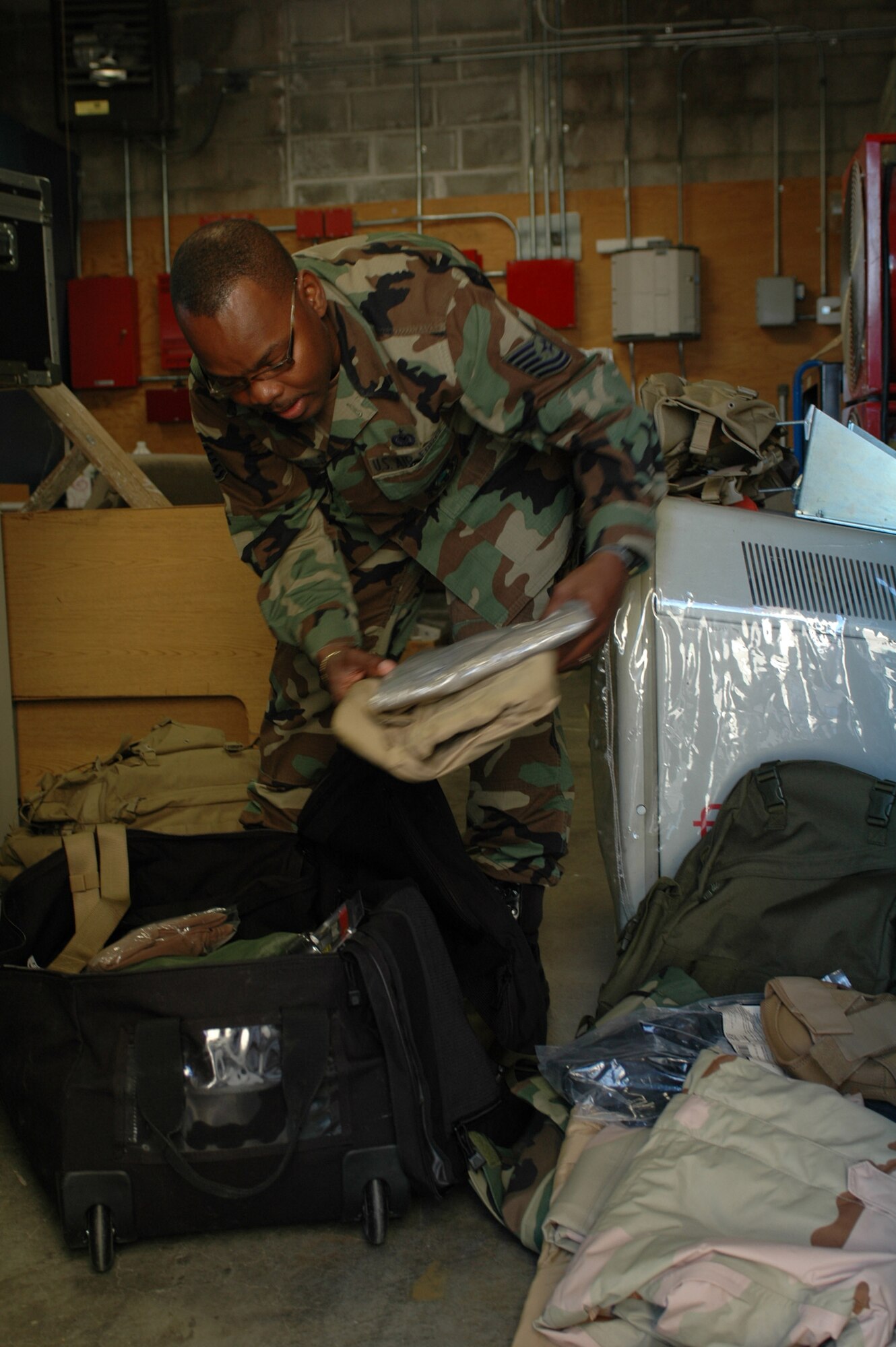 Tech. Sgt. Ricky Griswold unpacks and repacks deployment bags for the Office of Special Investigations. He was named the Air Force OSI Support Person of the Year. (U.S. Air Force photo by Jennifer Brugman)