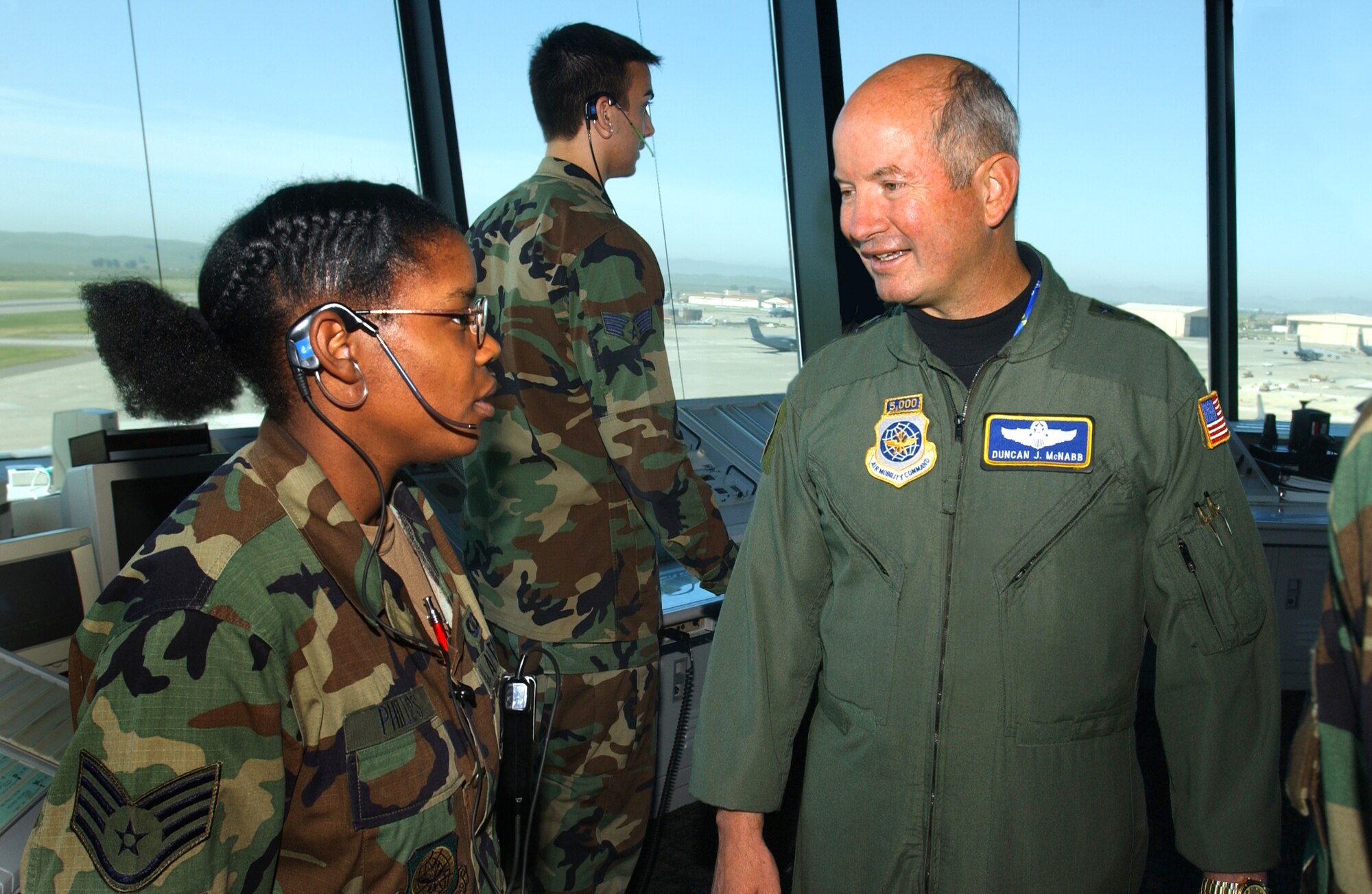 Staff Sgt. Romona Phillips, 60th Operations Support Squadron air traffic controller, discusses airfield operations with Gen. Duncan J. McNabb, Air Mobility Command commander, during his tour of the tower May 11. The general was also given a bird’s eye view of the base from the tower’s catwalk. (U.S. Air Force photo by Nan Wylie)